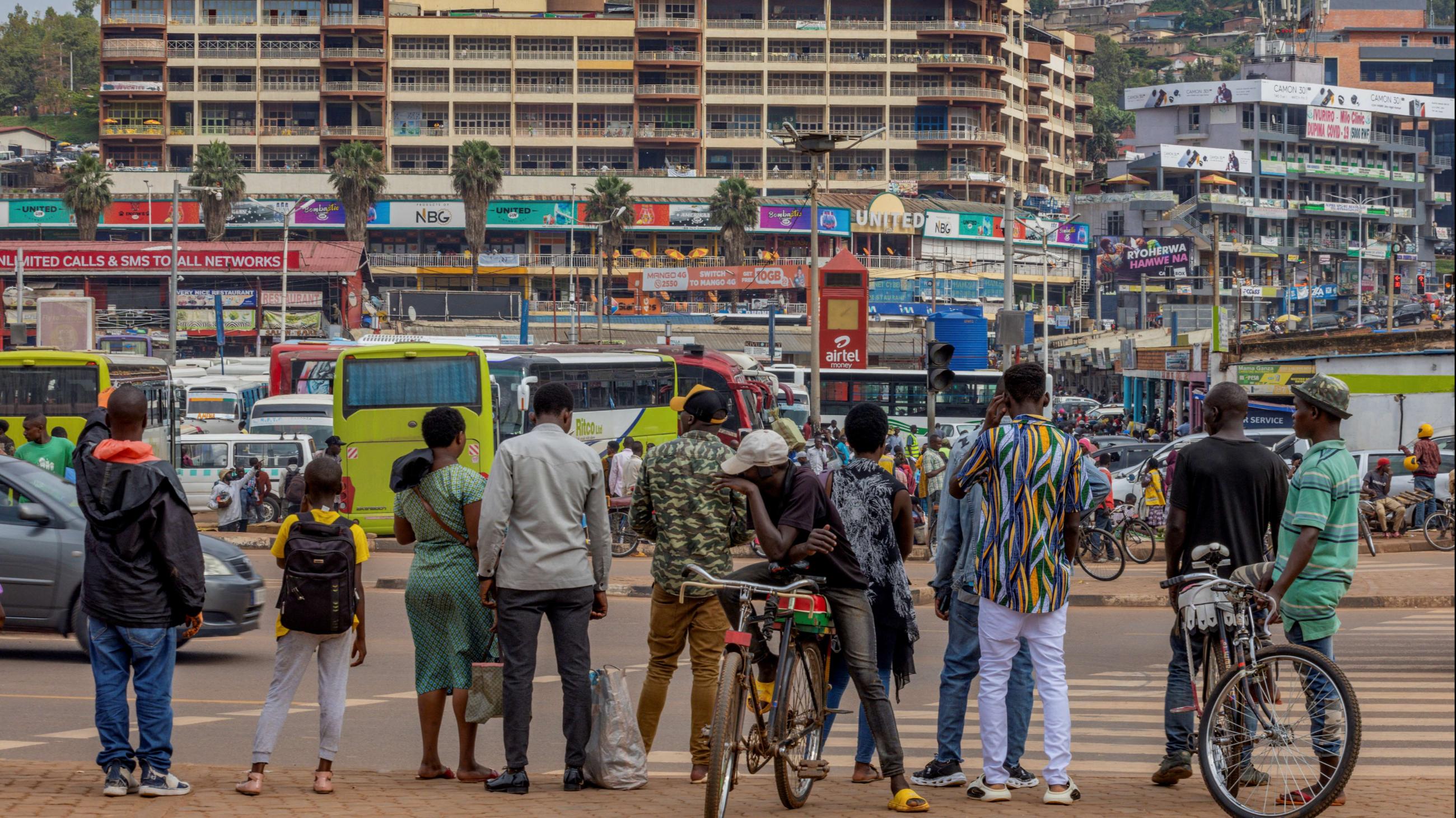 Pedestrians wait to cross a street in Kigali, Rwanda, April 26, 2024.