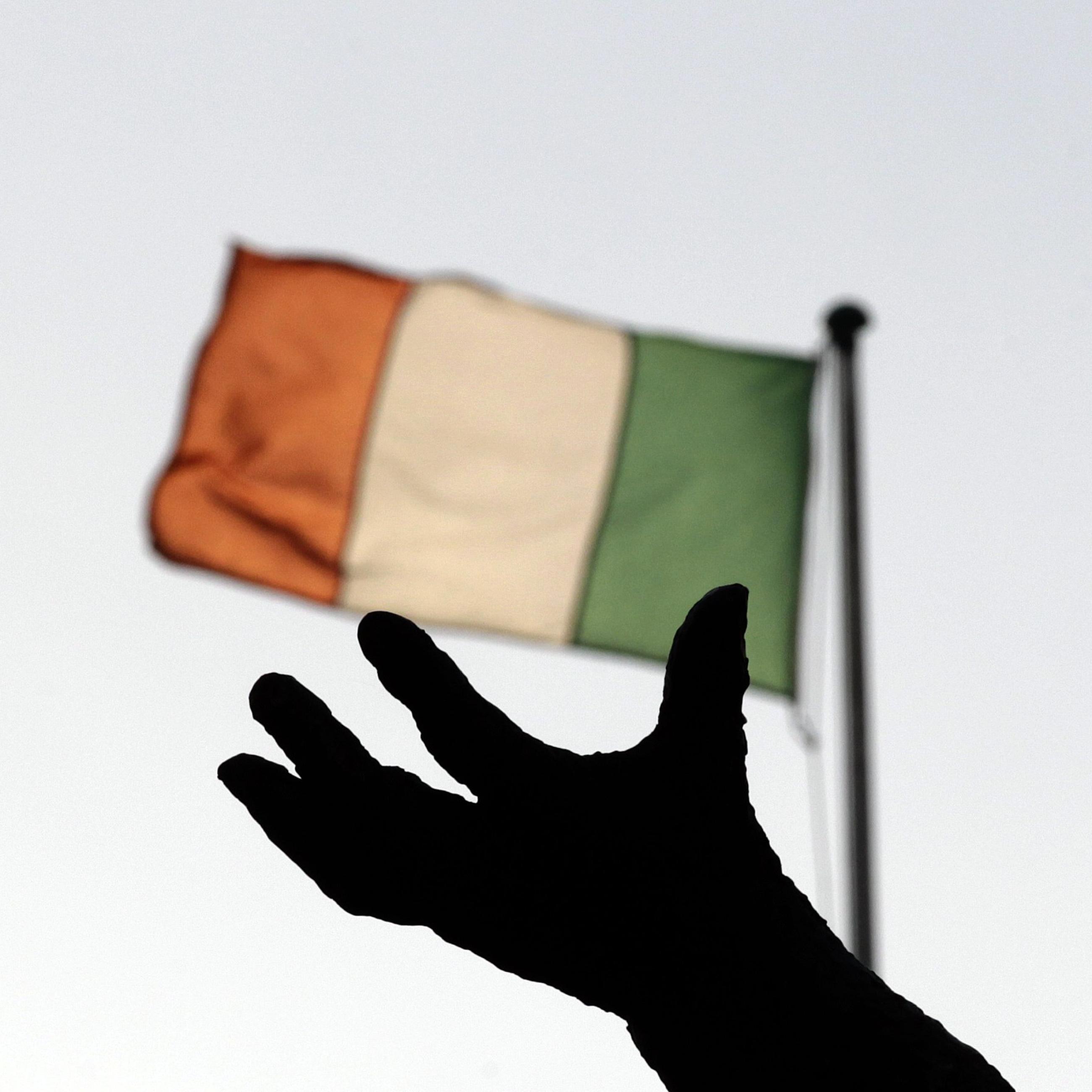 Ireland's national flag flies above a statue in Dublin