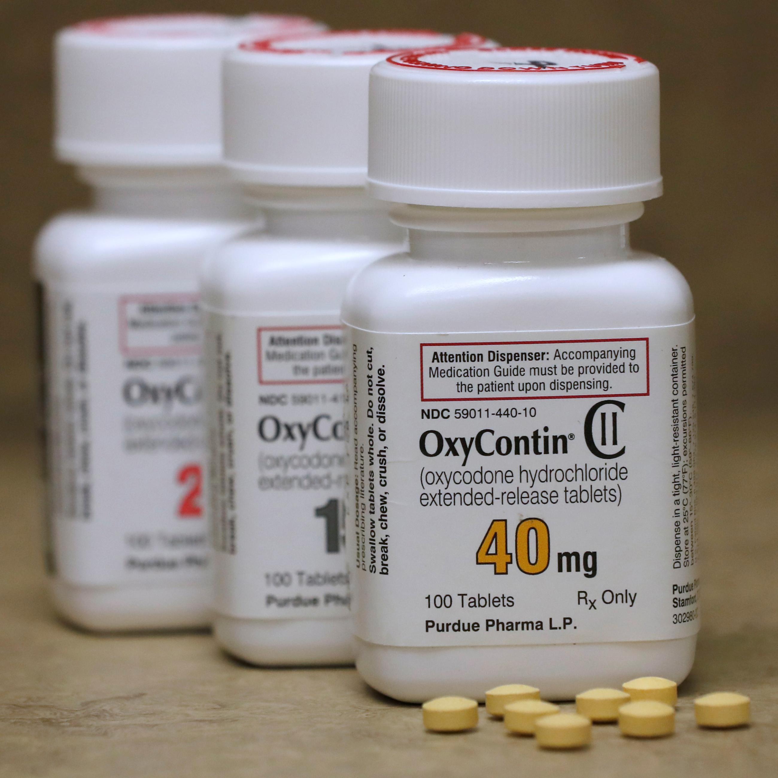 Bottles of prescription painkiller OxyContin, 40mg, 20mg, and 15mg pills, made by Purdue Pharma L.D. sit on a counter at a local pharmacy