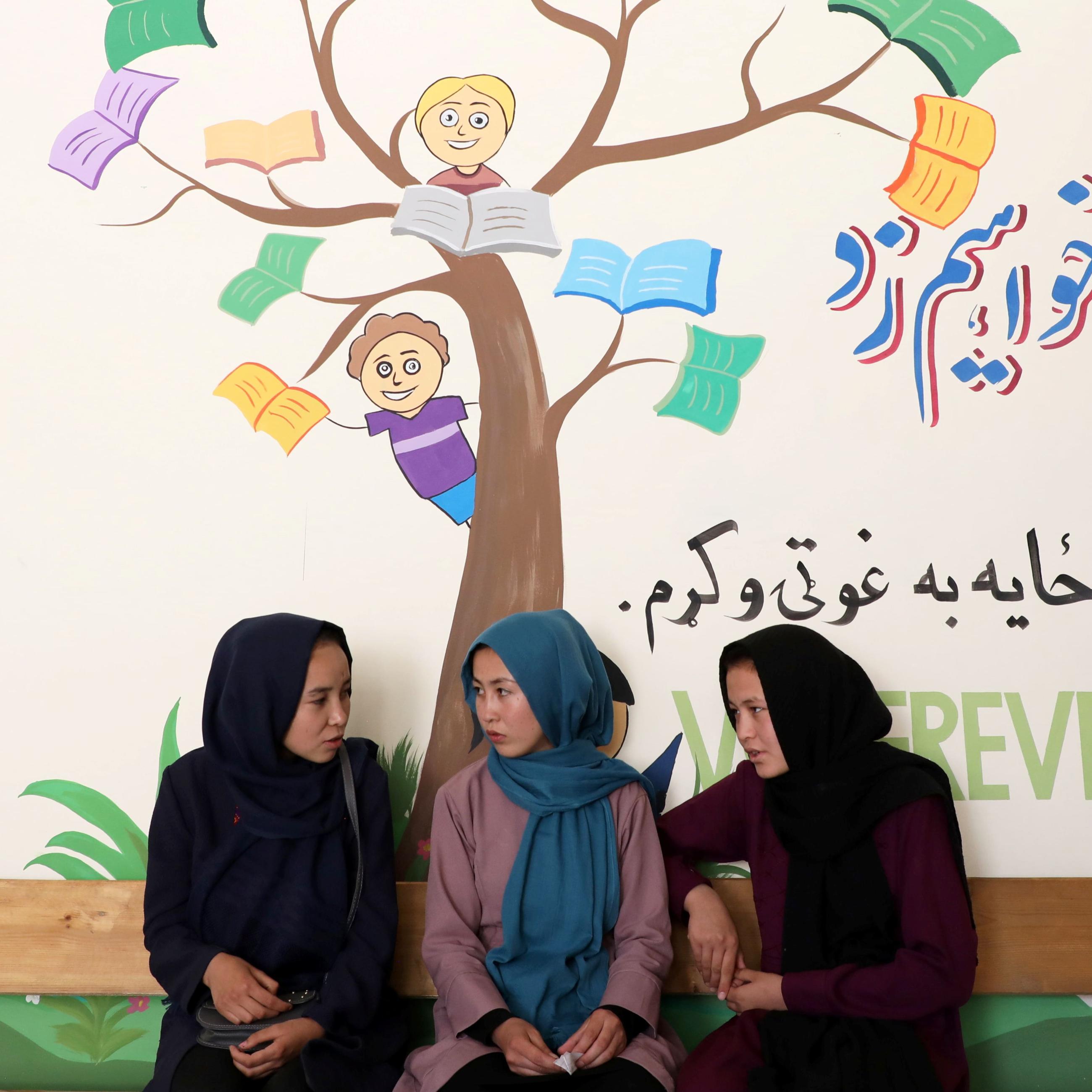 Fatima Noori (center), fifteen, talks with her classmates as she attends psychotherapy class after a massive bomb exploded outside their school that killed at least eighty students in Kabul, Afghanistan