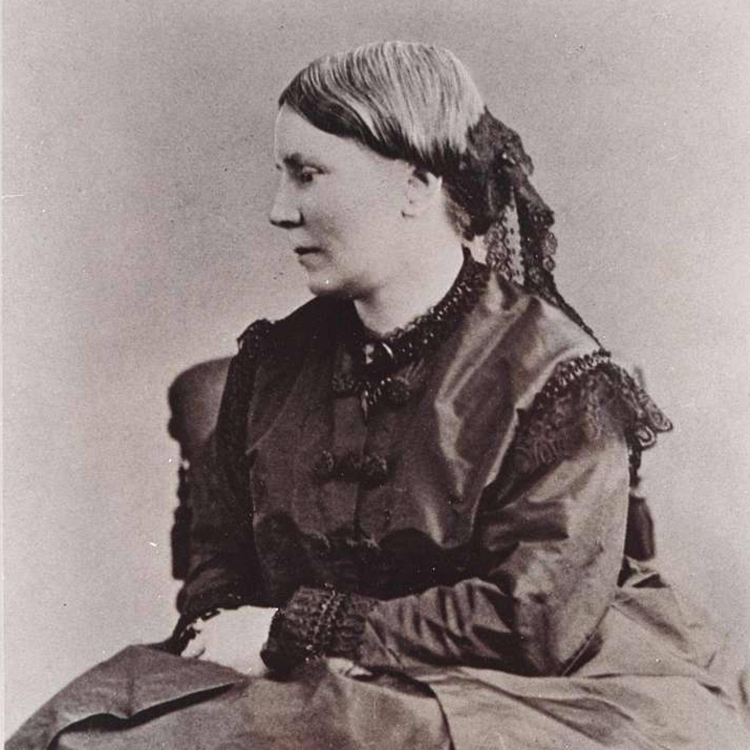 Portrait of Elizabeth Blackwell, a white woman in a black dress with fair hair seated in profile, ca. 1850–60.