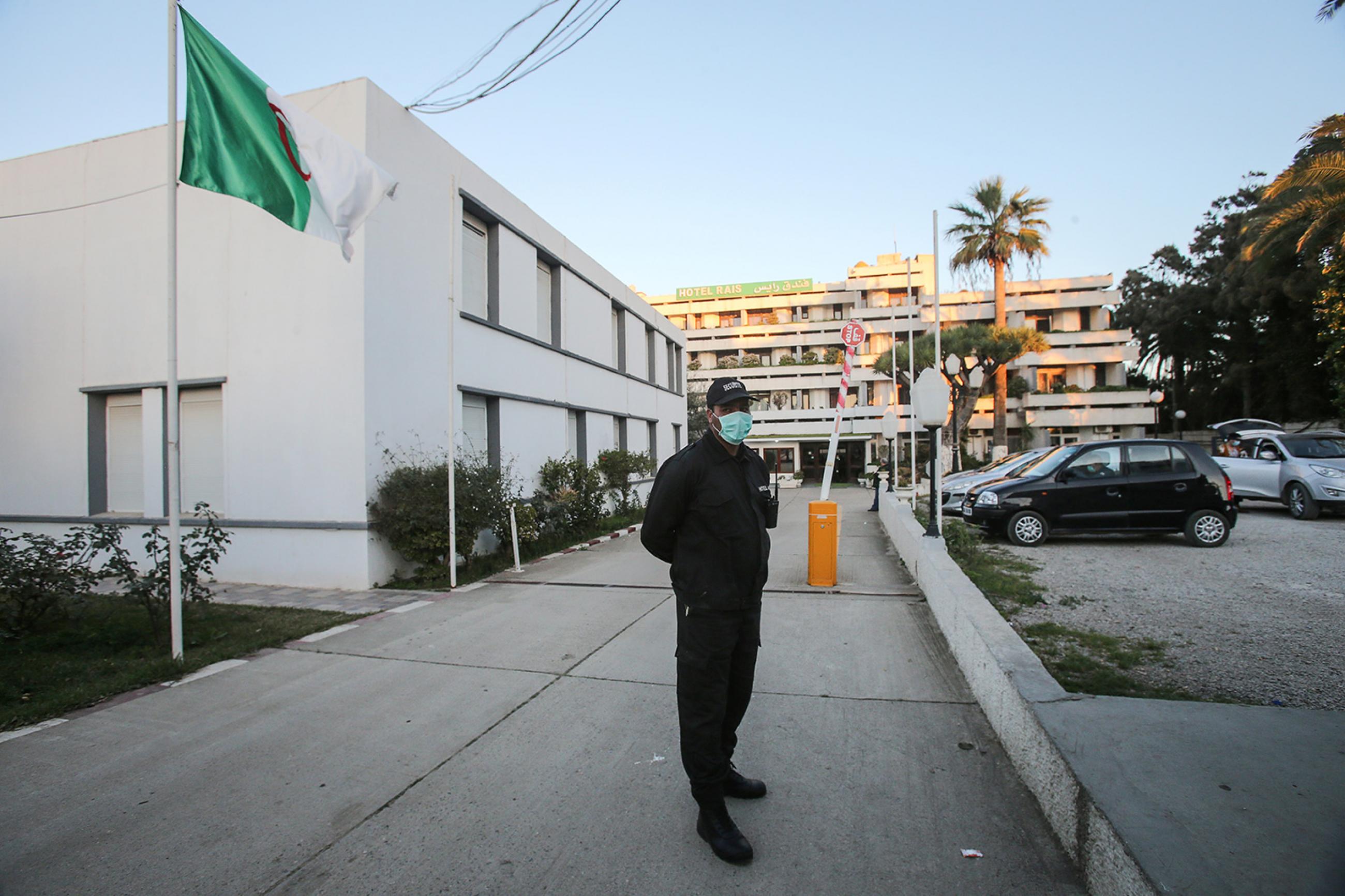 A security guard stands at attention at a hotel near Algiers, Algeria on Feb 4, 2020—where people evacuated from the Wuhan area in China are quarantined as a preventive measure because of coronavirus. Photo shows a guard wearing a face mask. REUTERS/Ramzi Boudina