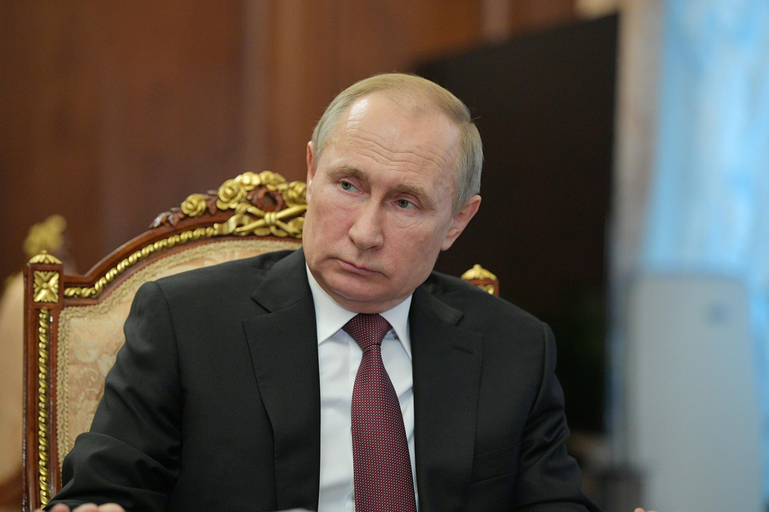 Russian President Vladimir Putin chairs a meeting in Moscow on preventing the spread of coronavirus in Russia on January 29, 2020. The picture shows Putin sitting in a chair listening. REUTERS/Sputnik/Alexei Druzhinin/Kremlin photo