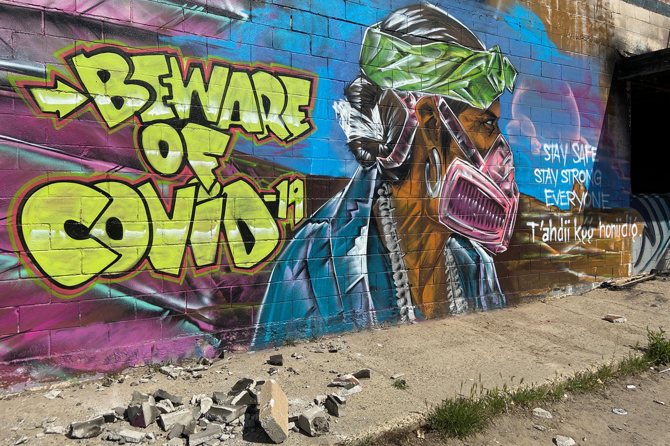 A mural warns residents of the danger of coronavirus disease (COVID-19) outbreak on the Navajo reservation, in Shiprock, New Mexico, U.S., April 8, 2020. Picture shows an amazing mural of a man wearing a mask painted on the side of a wall. REUTERS/Andrew Hay