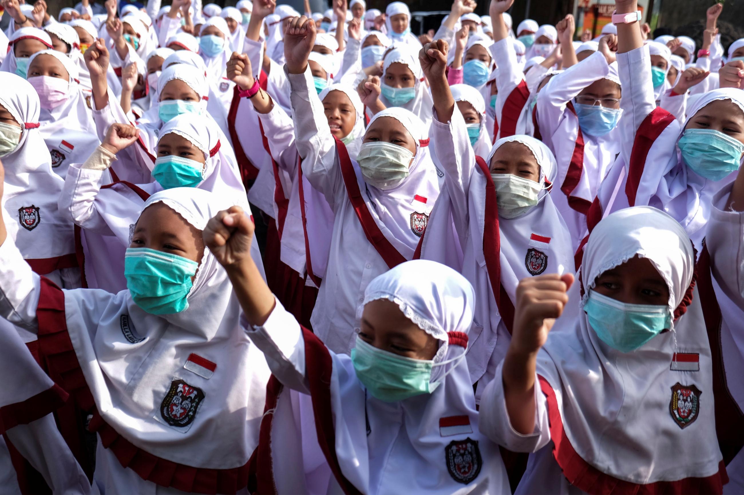 Students wear face masks during a health-care action rally dedicated to COVID-19 in Solo, Central Java, Indonesia on February 3, 2020 