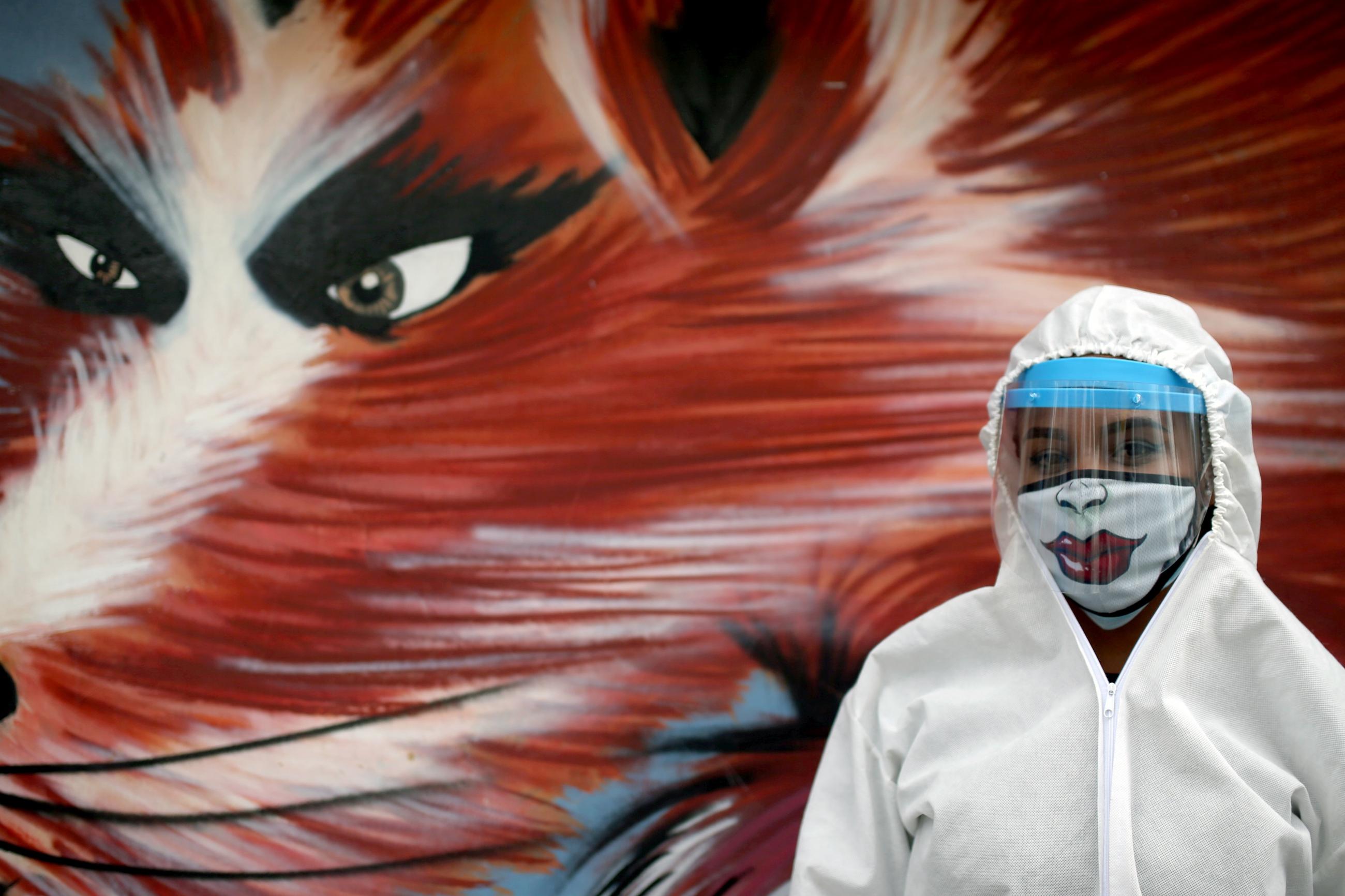 A city employee wearing protective gear poses for a photo during a citywide personal care day, amid the coronavirus disease outbreak in Bogota, Colombia on April 17, 2020.