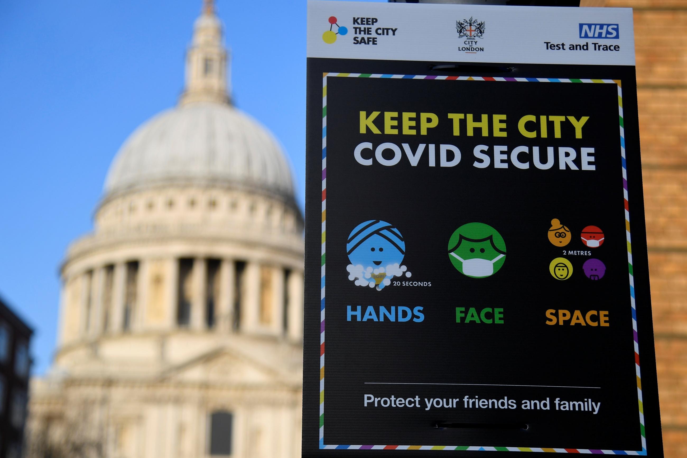A public health information sign is seen with St. Paul's Cathedral seen behind amidst a lockdown during the spread of the coronavirus disease pandemic, London, Britain, January 7, 2021.