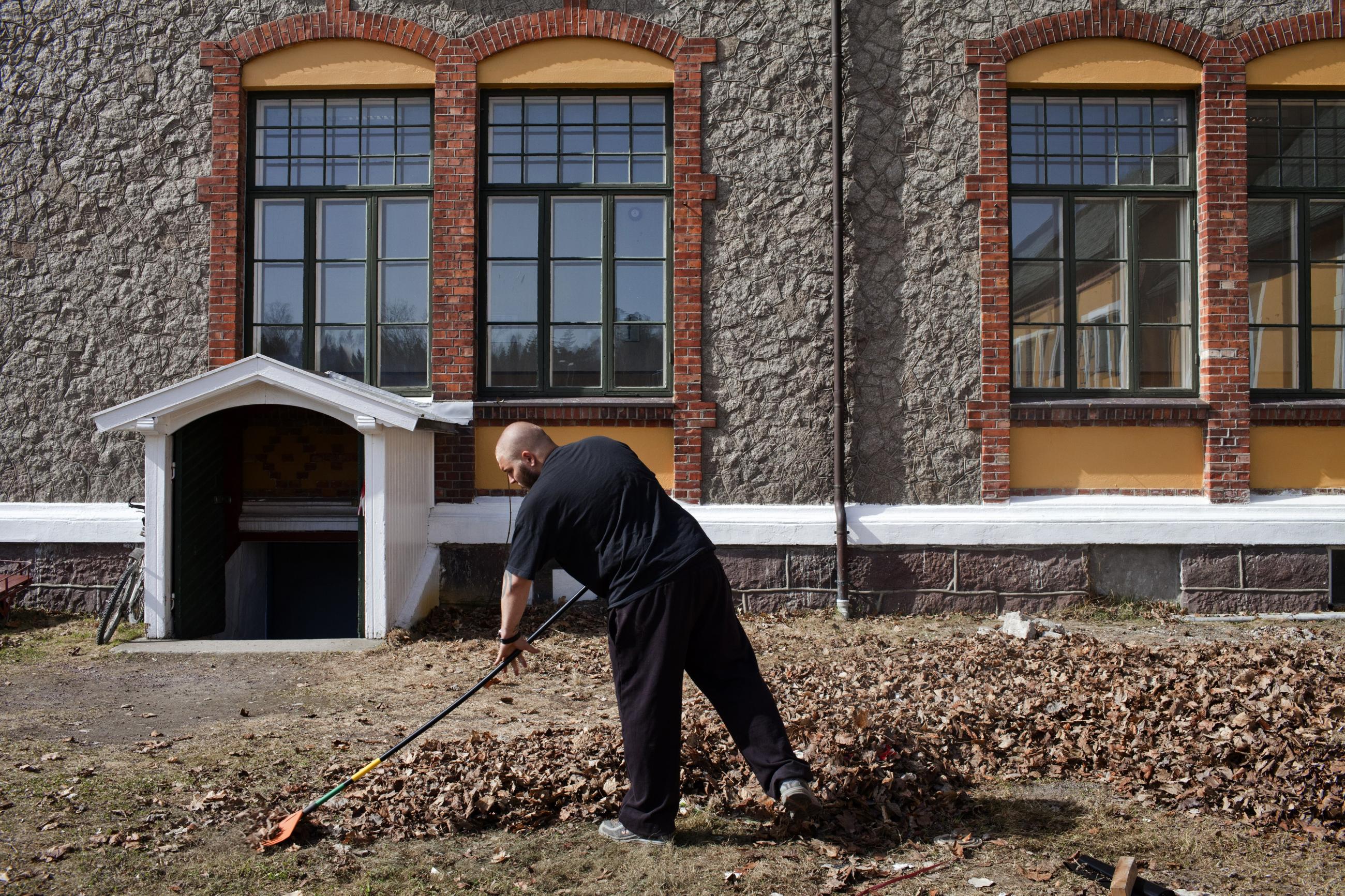 An inmate sentenced to ten months rakes leaves in Bastoy Prison in Horten, Norway on April 11, 2011. 