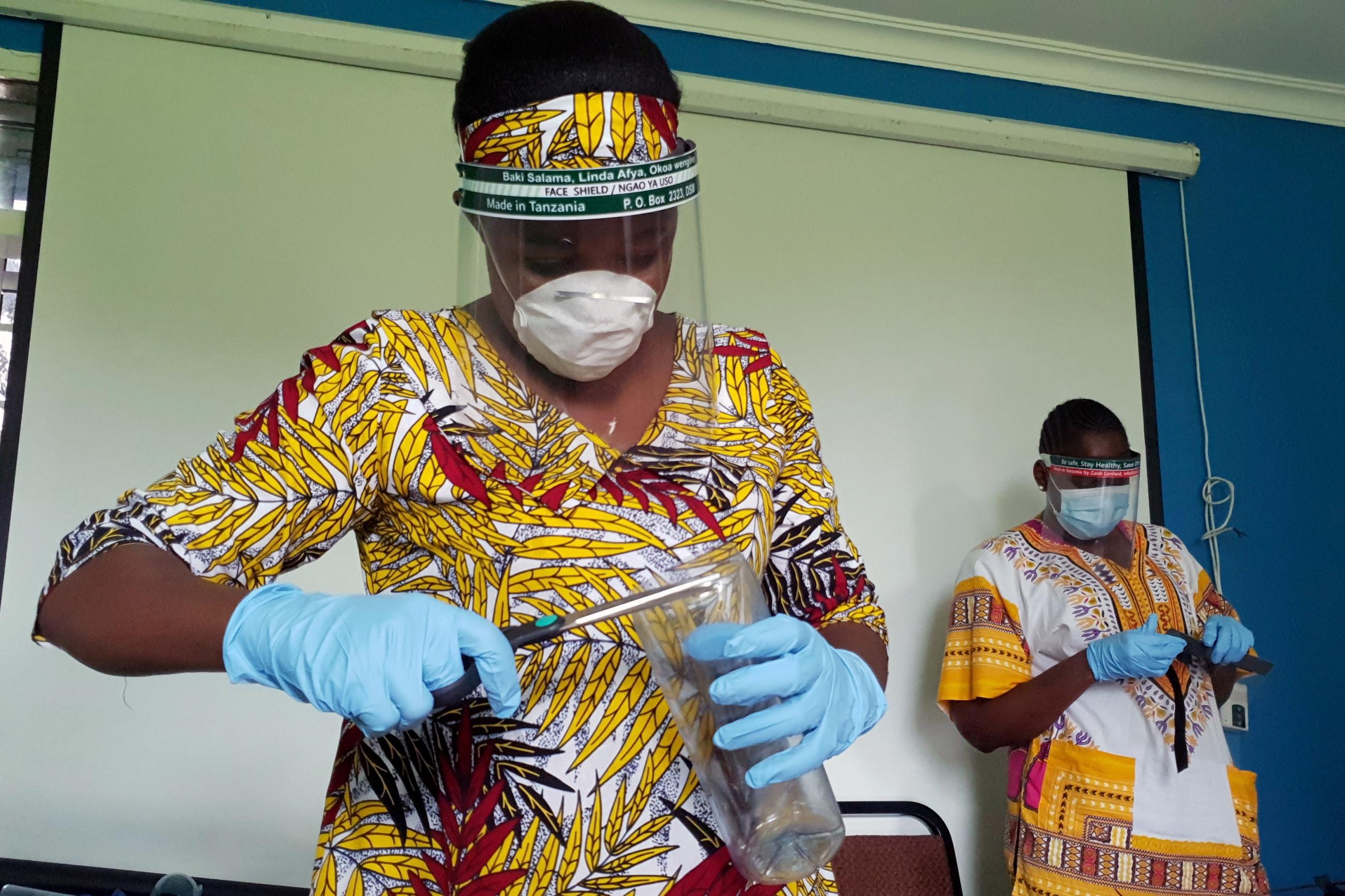 Workers prepare face shields from recycled plastics at the Zaidi Recyclers workshop as a measure to stop the spread of coronavirus disease in Dar es Salaam, Tanzania on May 21, 2020.