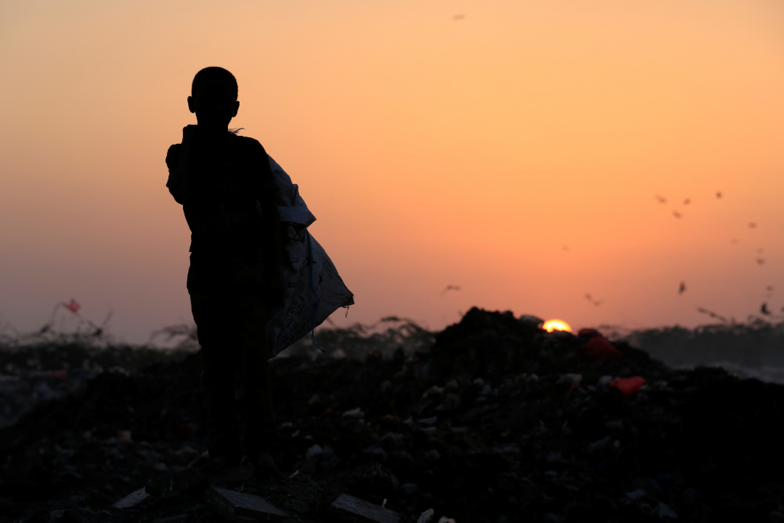 A boy stands in a garbage dump—where his family collects food to eat—near the Red Sea port city of Hodeidah, Yemen on January 13, 2018. REUTERS/Abduljabbar Zeyad