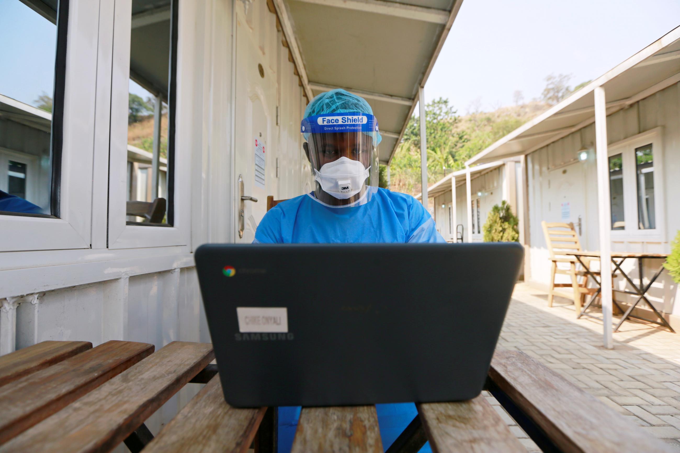  health professional works on a computer at a drive-through sample collection centre for coronavirus disease (COVID-19) in Abuja, Nigeria January 14, 2021.