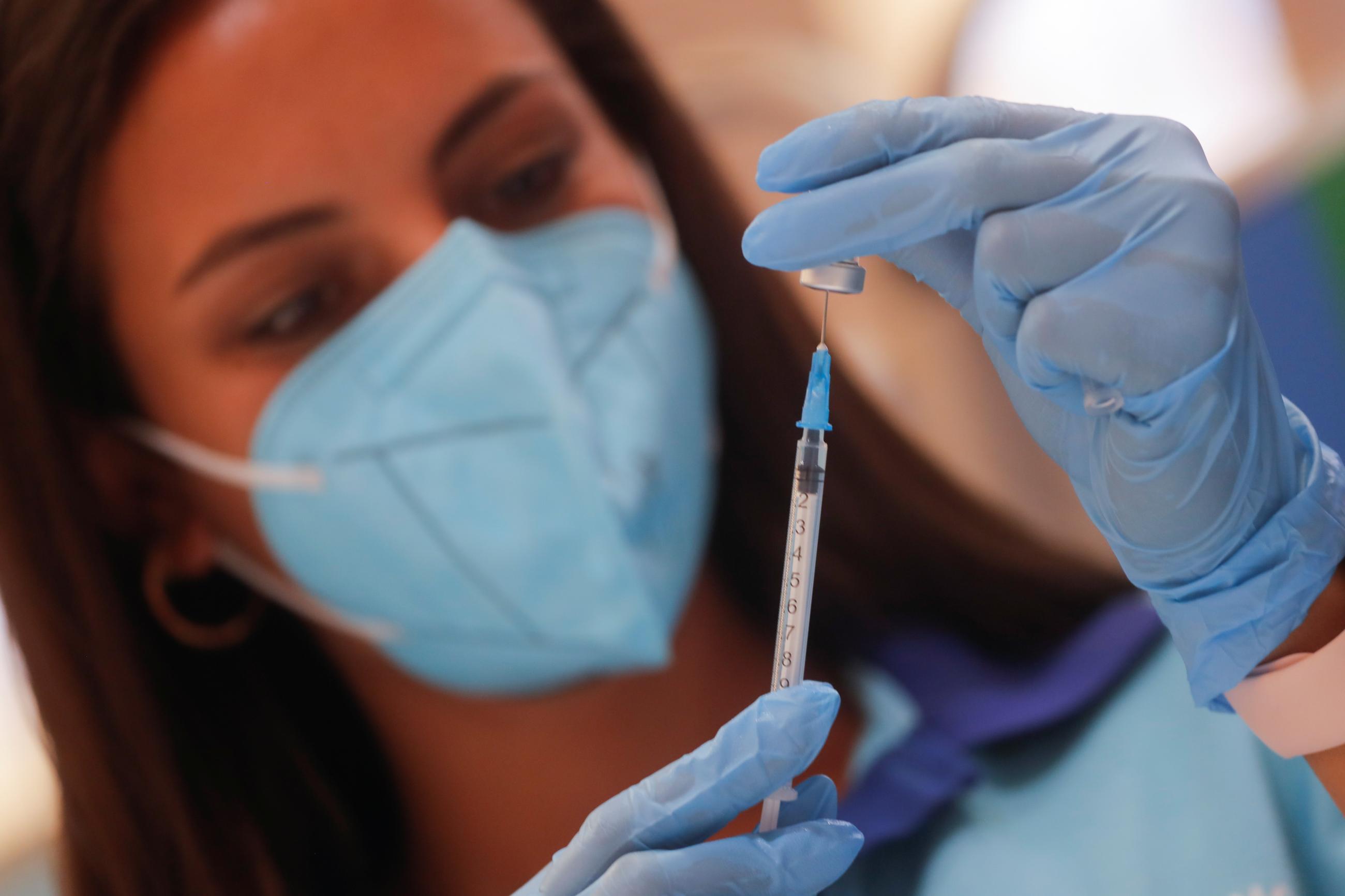 A healthcare worker prepares a dose of the "Comirnaty" Pfizer BioNTech COVID-19 vaccine against the coronavirus disease (COVID-19) at a vaccination centre in Ronda, Spain