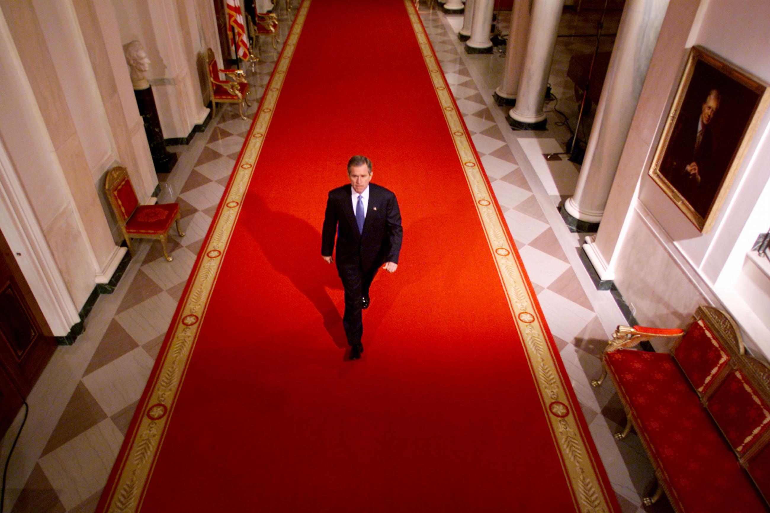 George W Bush walks down the White house halls to the address the nation on the attacks on 9/11