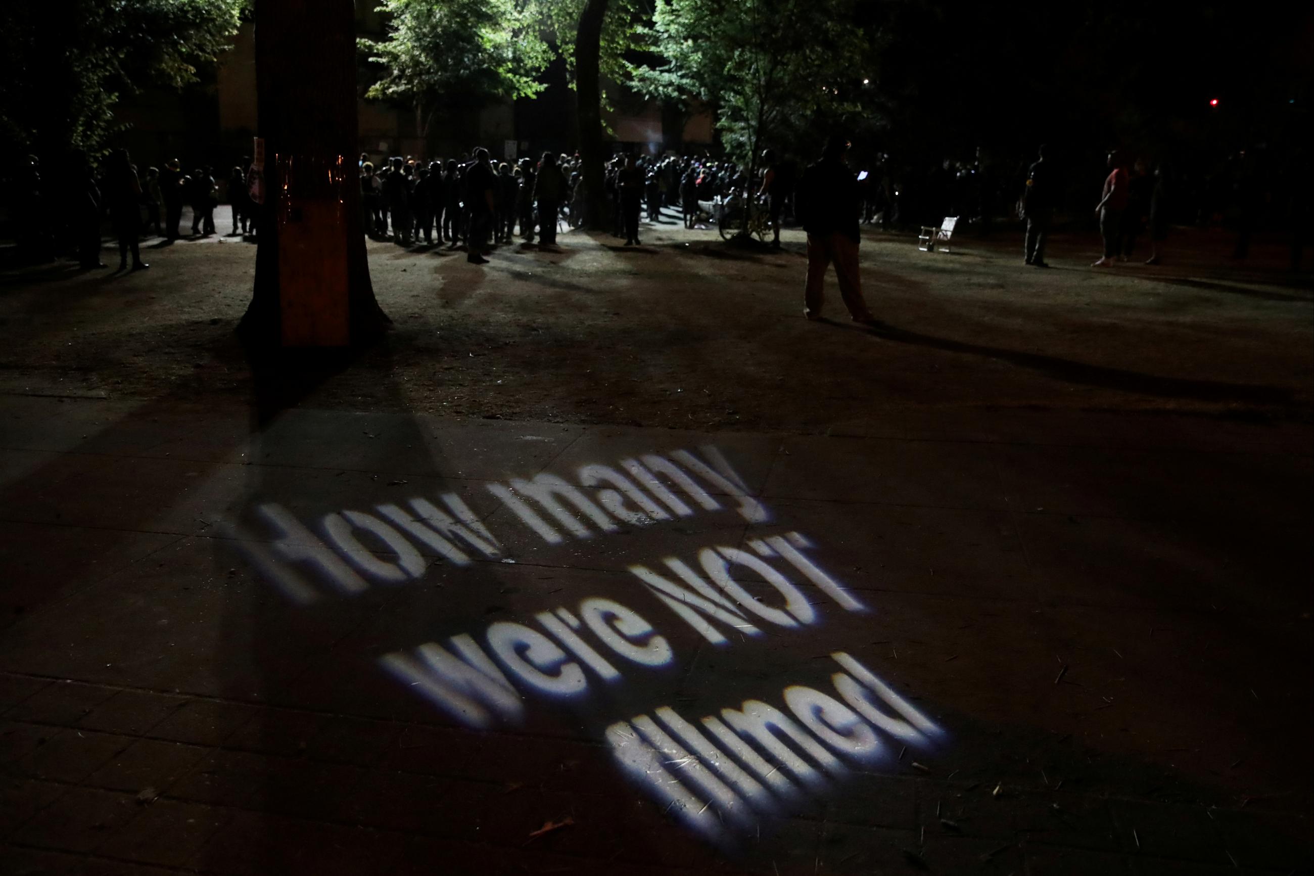 A protester casts a projection during a demonstration against police violence and racial inequality in Portland, Oregon, U.S., August 1, 2020. 