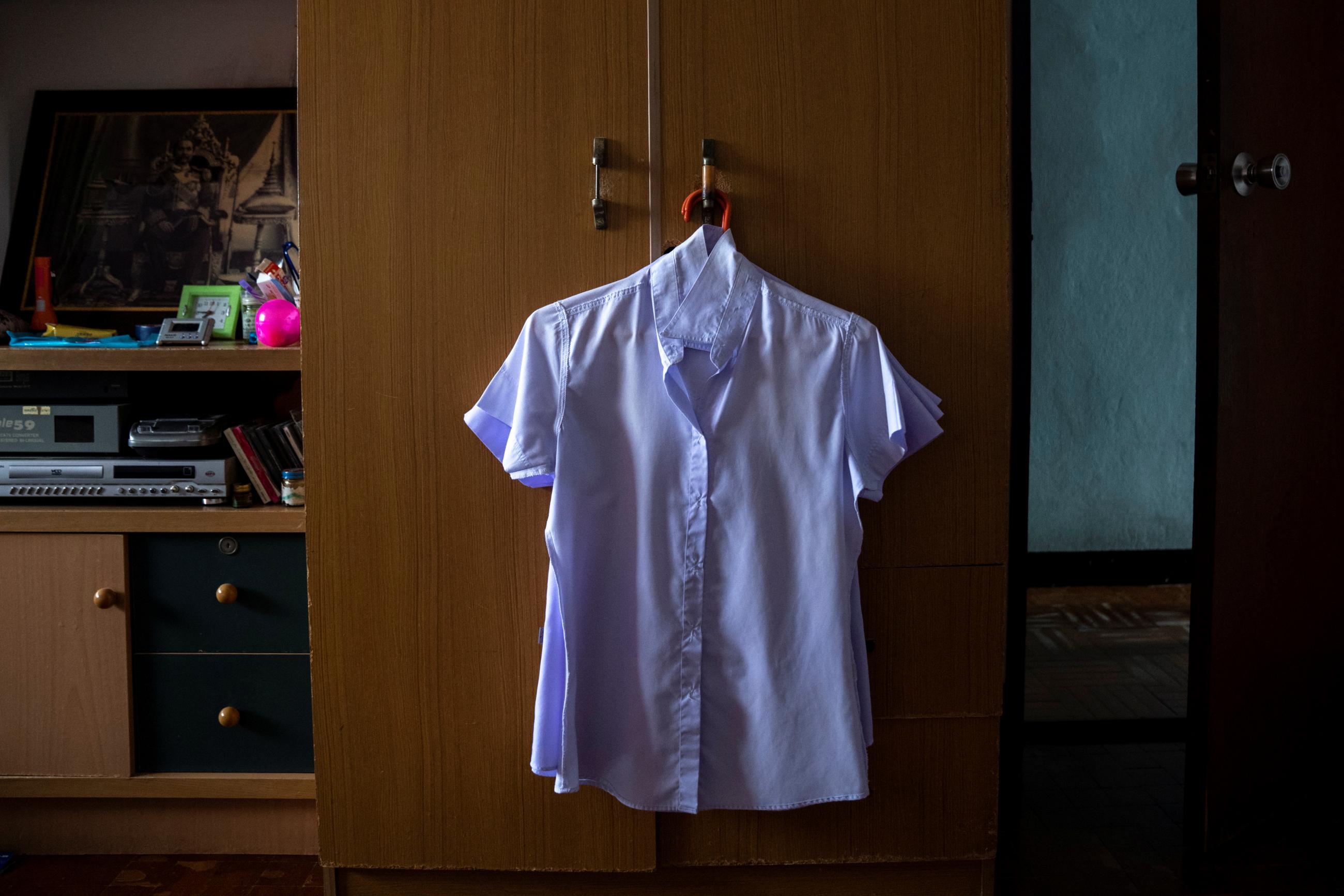 A work uniform hangs in the wardrobe of Nitiwadee Sae-Tia, 50, who took her own life after losing her job during the COVID outbreak in Bangkok, Thailand. Photo taken on May 26, 2020.