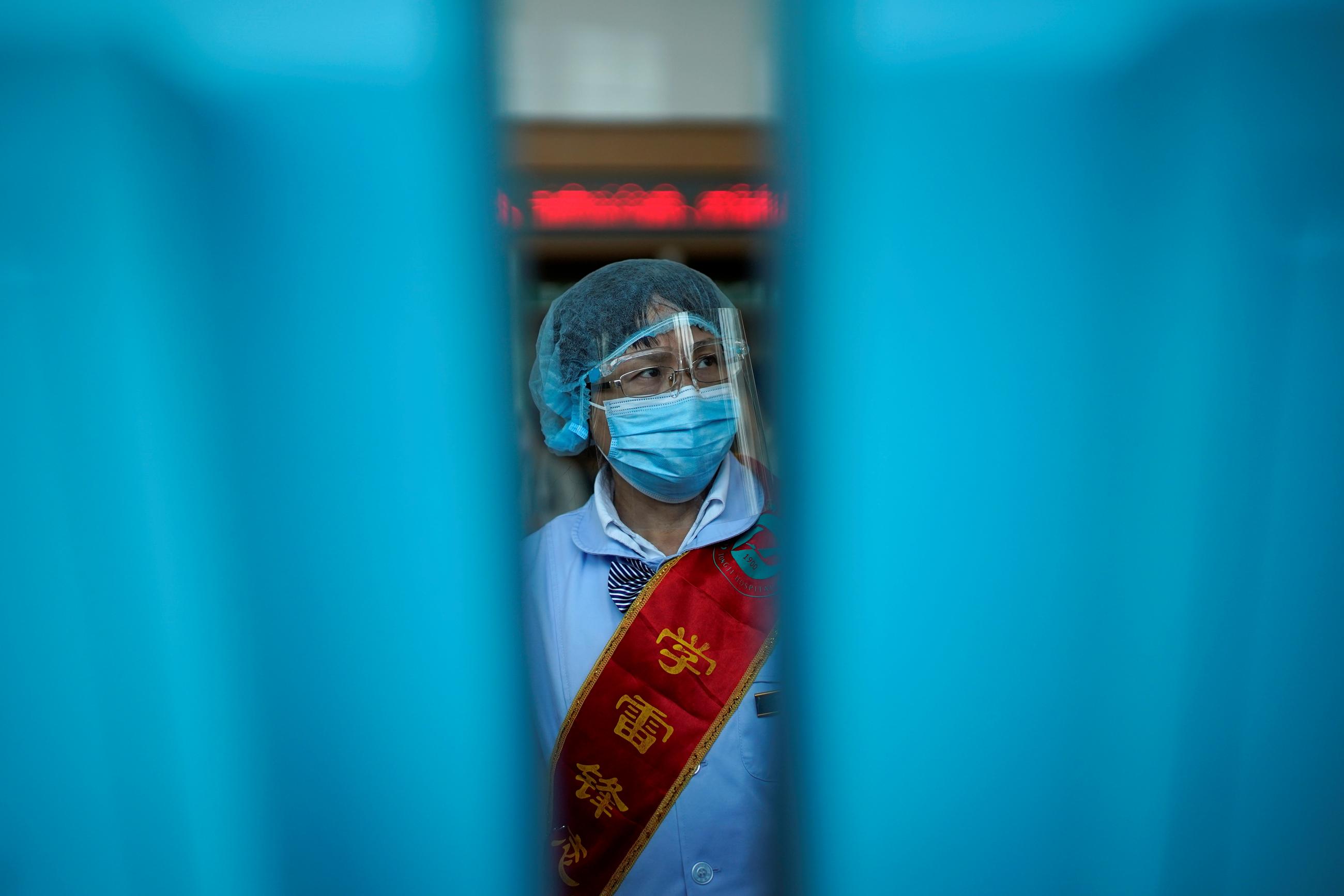  worker wears a mask and a face shield during a government organised media tour at Tongji Hospital following the coronavirus disease (COVID-19) outbreak, in Wuhan, Hubei province, China 