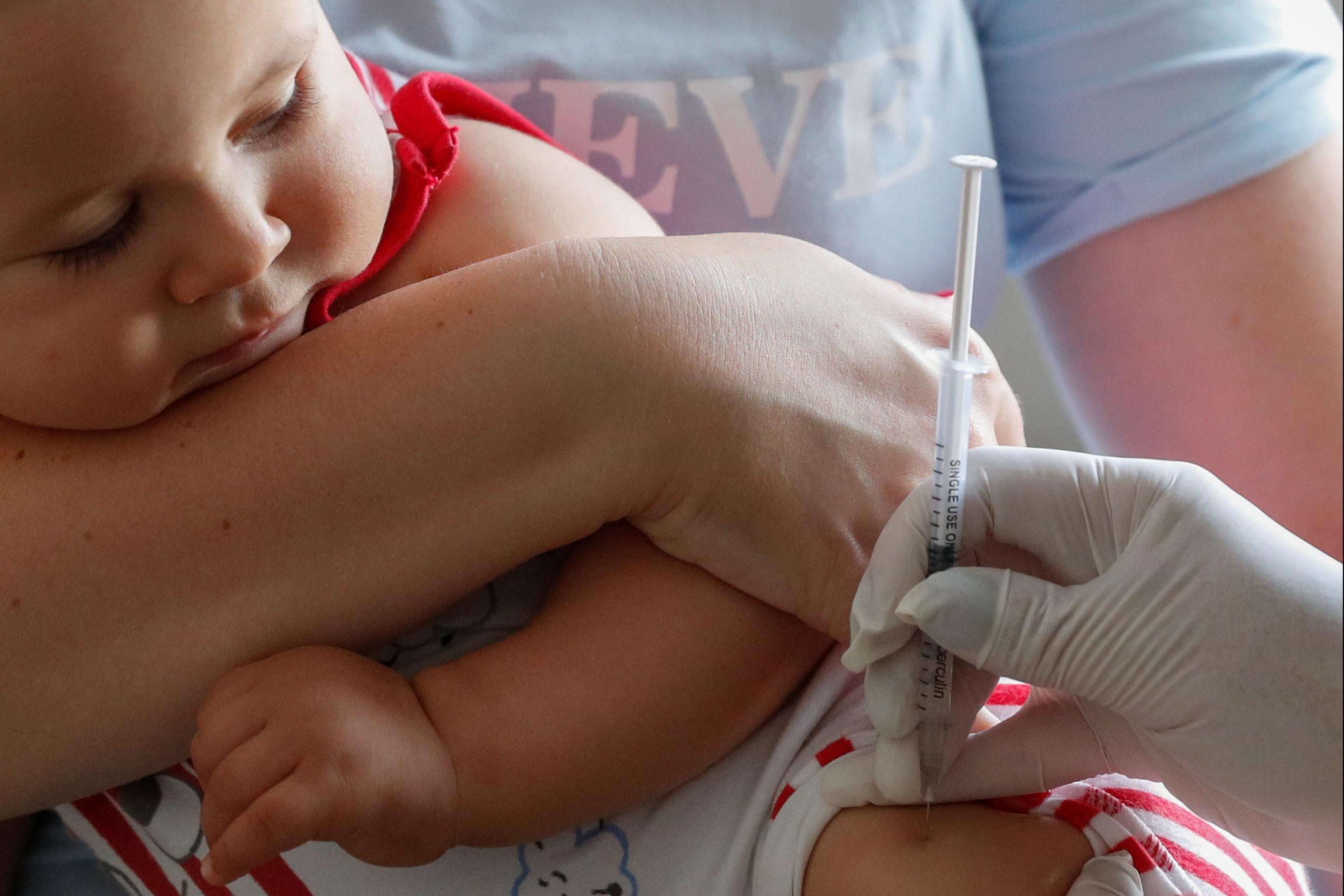 A baby receives a vaccine injection at a children's clinic in Kiev, Ukraine, on August 14, 2019.  Photo by REUTERS/Valentyn Ogirenko