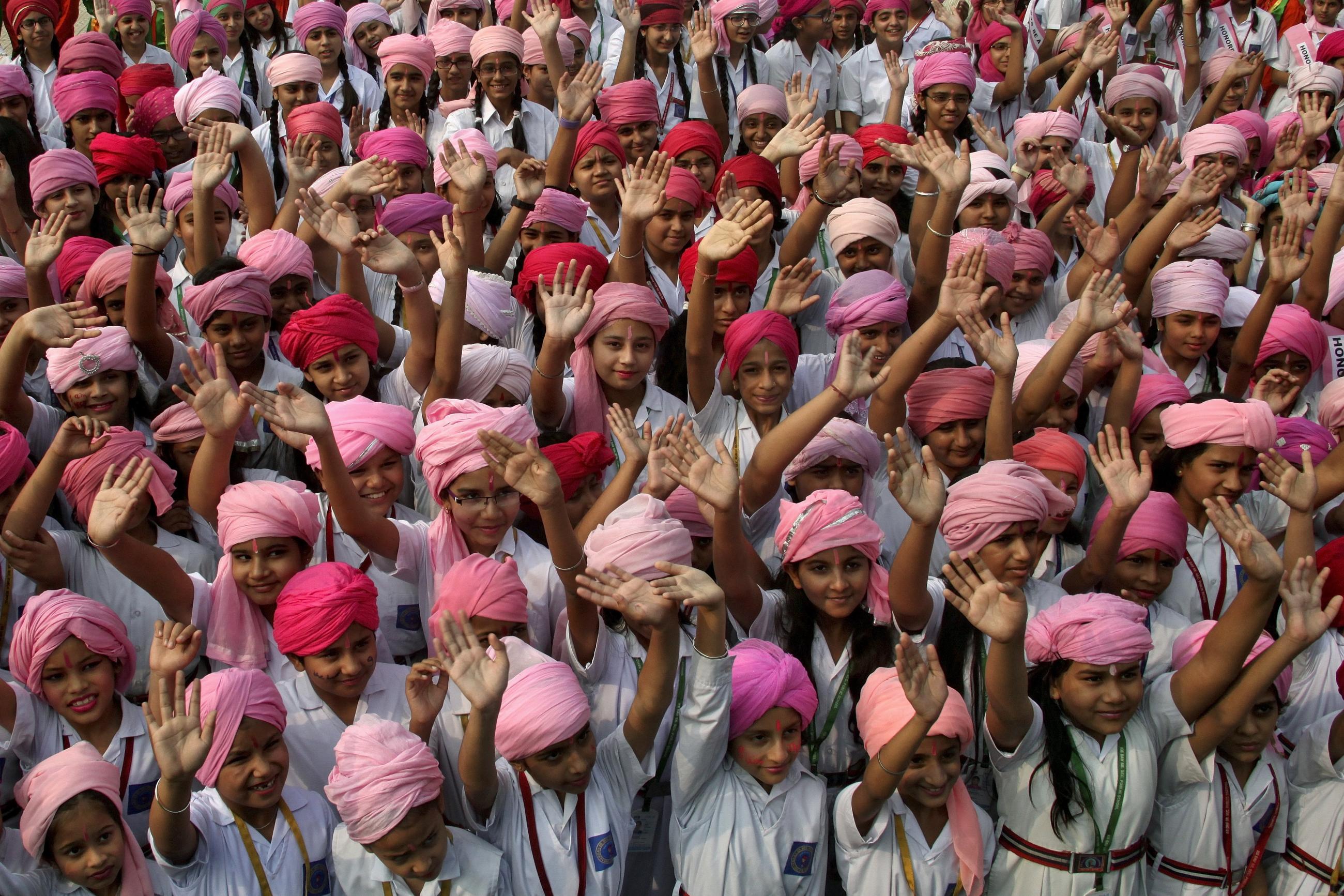 Girls wave as they take part in celebrations to mark the International Day of the Girl Child at a school in Chandigarh, India, on October 12, 2015. 