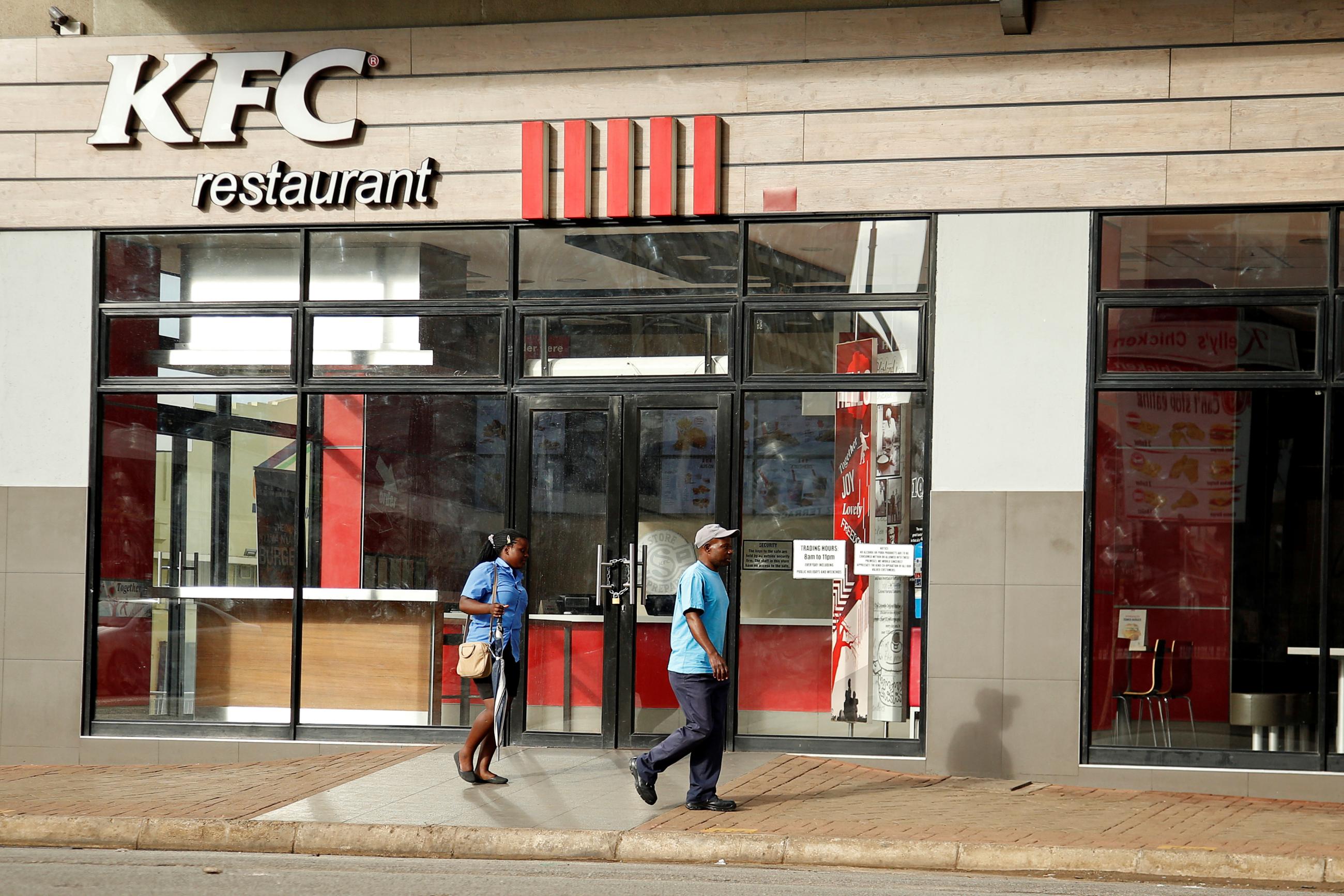 People walk past a KFC outlet in Harare, Zimbabwe, on January 16, 2019. REUTERS/Philimon Bulawayo