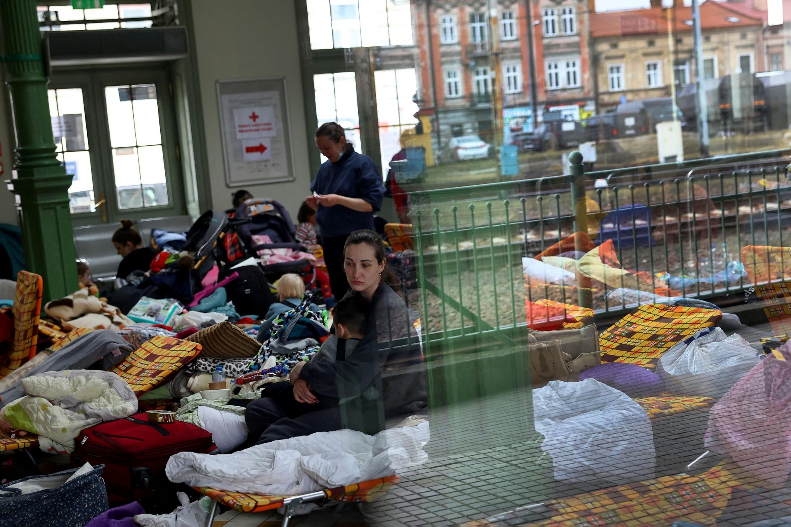 Refugees who fled from the Russian invasion in Ukraine rest inside a temporary camp at the train station in Przemysl, Poland, March 2, 2022.