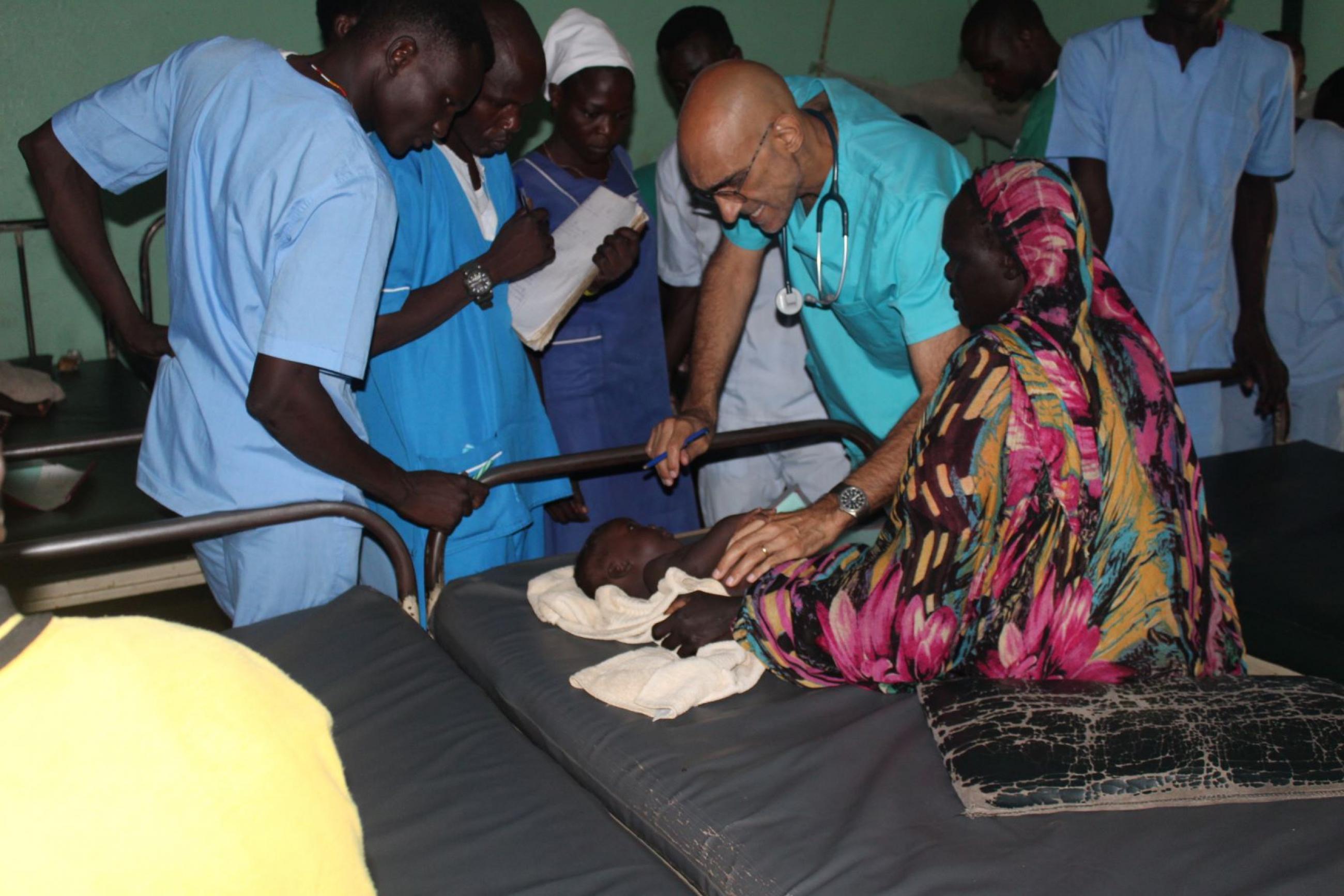 Dr. Tom Catena tends to a patient, at Mother of Mercy hospital, in Sudan.