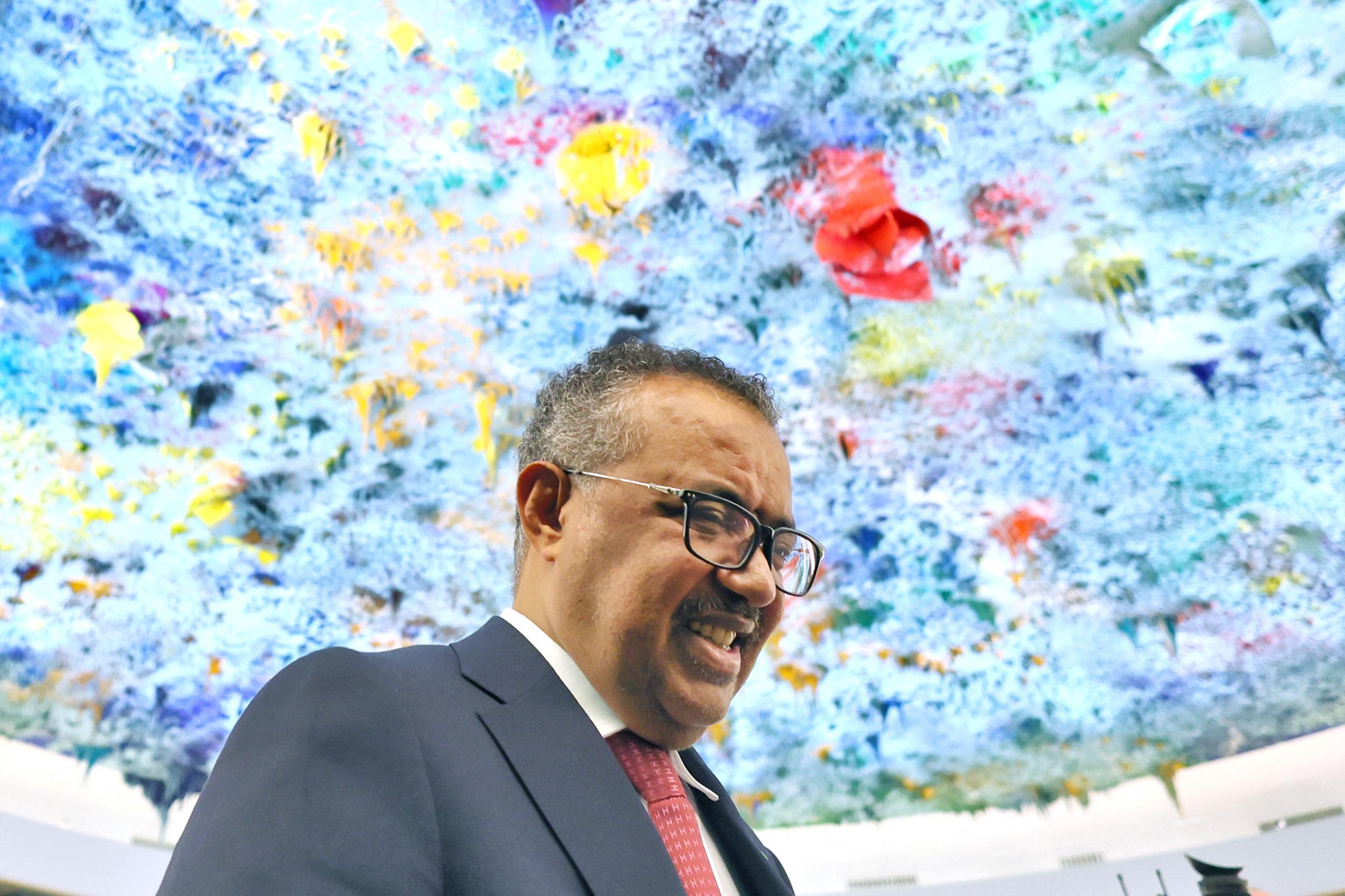 A blue, purple, and yellow skylight hovers above Dr. Tedros Adhanom Ghebreyesus, director-general of the World Health Organization (WHO) celebrates his re-election during the 75th World Health Assembly at the United Nations in Geneva, Switzerland, May 24, 2022. 