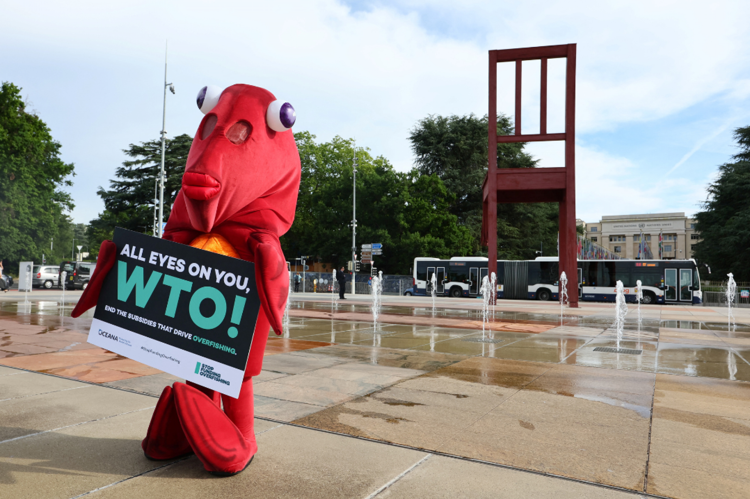 Finley the fish, a person dressed in a life-size red fish costume, poses during World Ocean Day ahead of the World Trade Organization Ministerial Conference (MC12) holding a sign to protest harmful fisheries subsidies. Photo taken in Geneva, Switzerland on June 8, 2022.