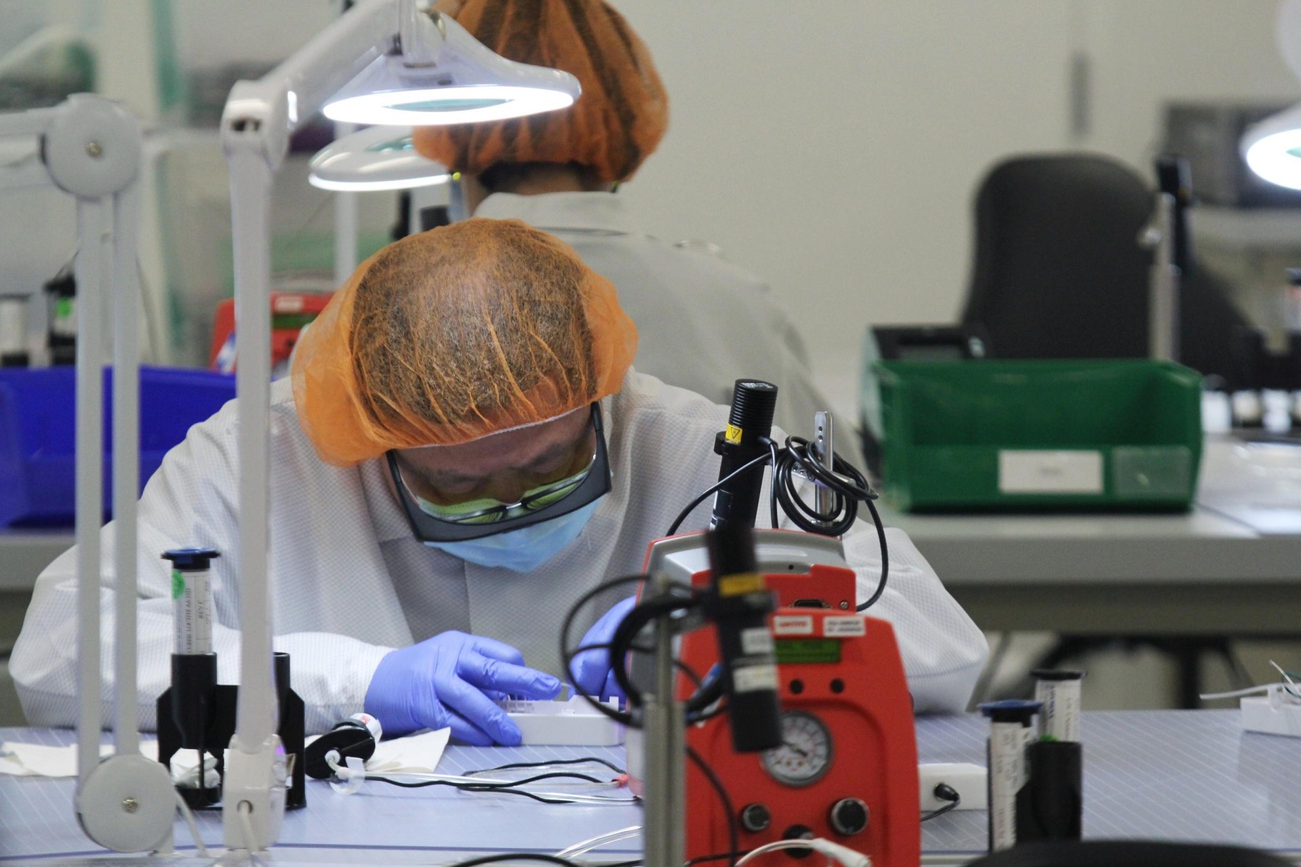 A worker assembles parts of a COVID-19 test kit made by Visby Medical at the kit maker's lab in San Jose, California, U.S., August 28, 2020.