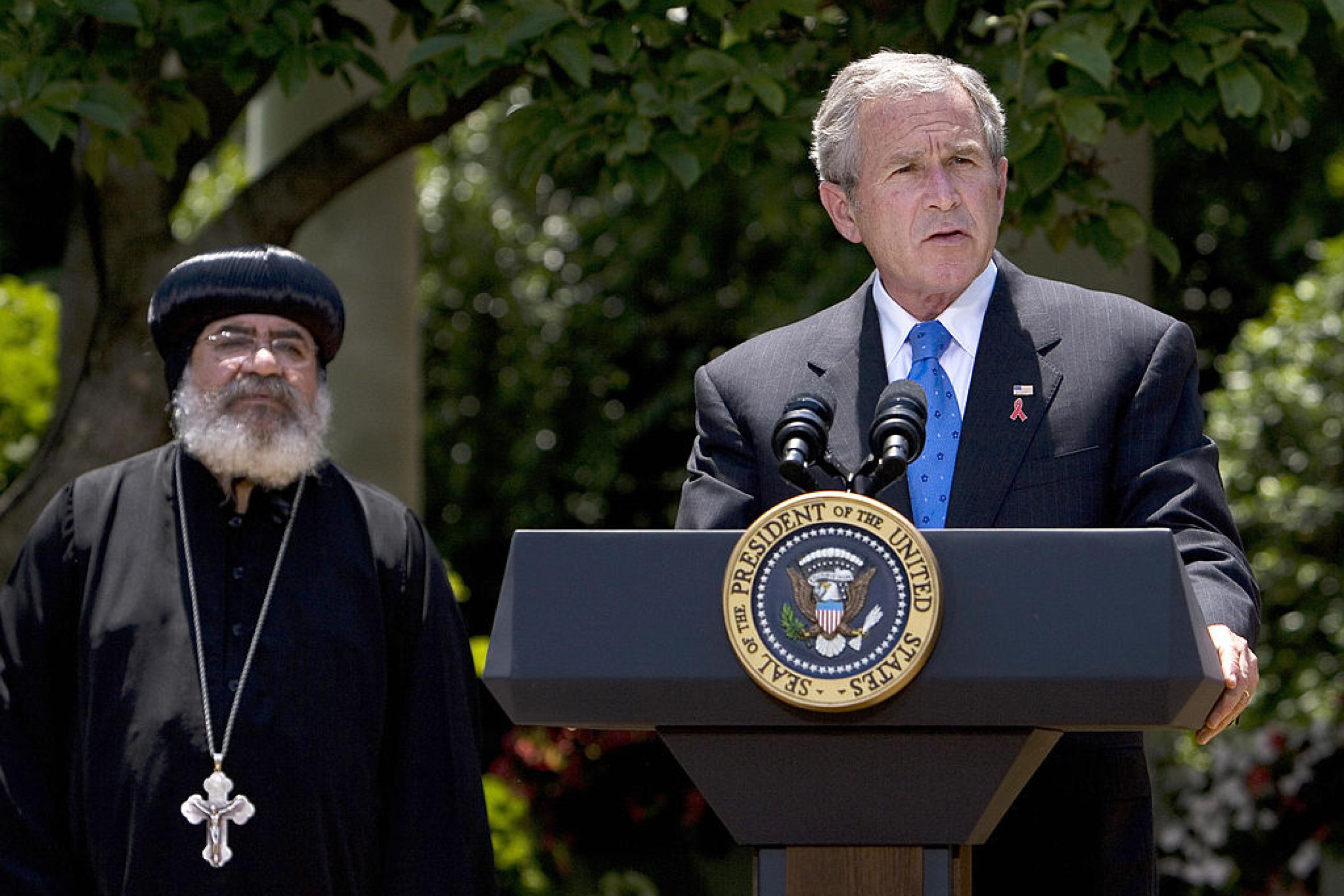 US President George W. Bush speaks on the President's Emergency Plan for AIDS Relief as Bishop Paul Yowakim looks on 30 May 2007 in the Rose Garden of the White House in Washington, DC.