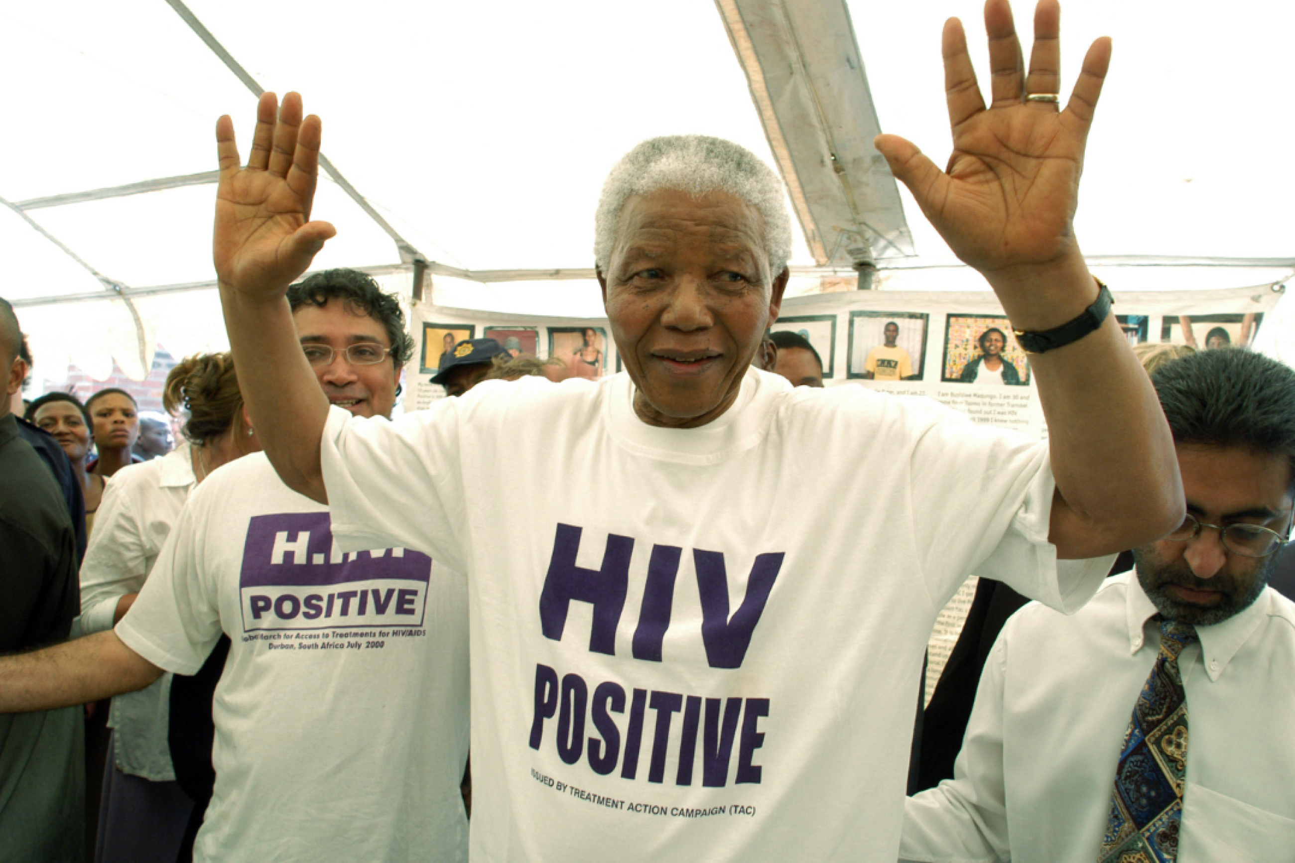 Former president of South Africa Nelson Mandela—wearing a white t-shirt with HIV POSITIVE in purple printed on the front—visits the township of Khayelitsha in Western Cape, South Africa. Photo by Media24/Gallo Images/Getty Images