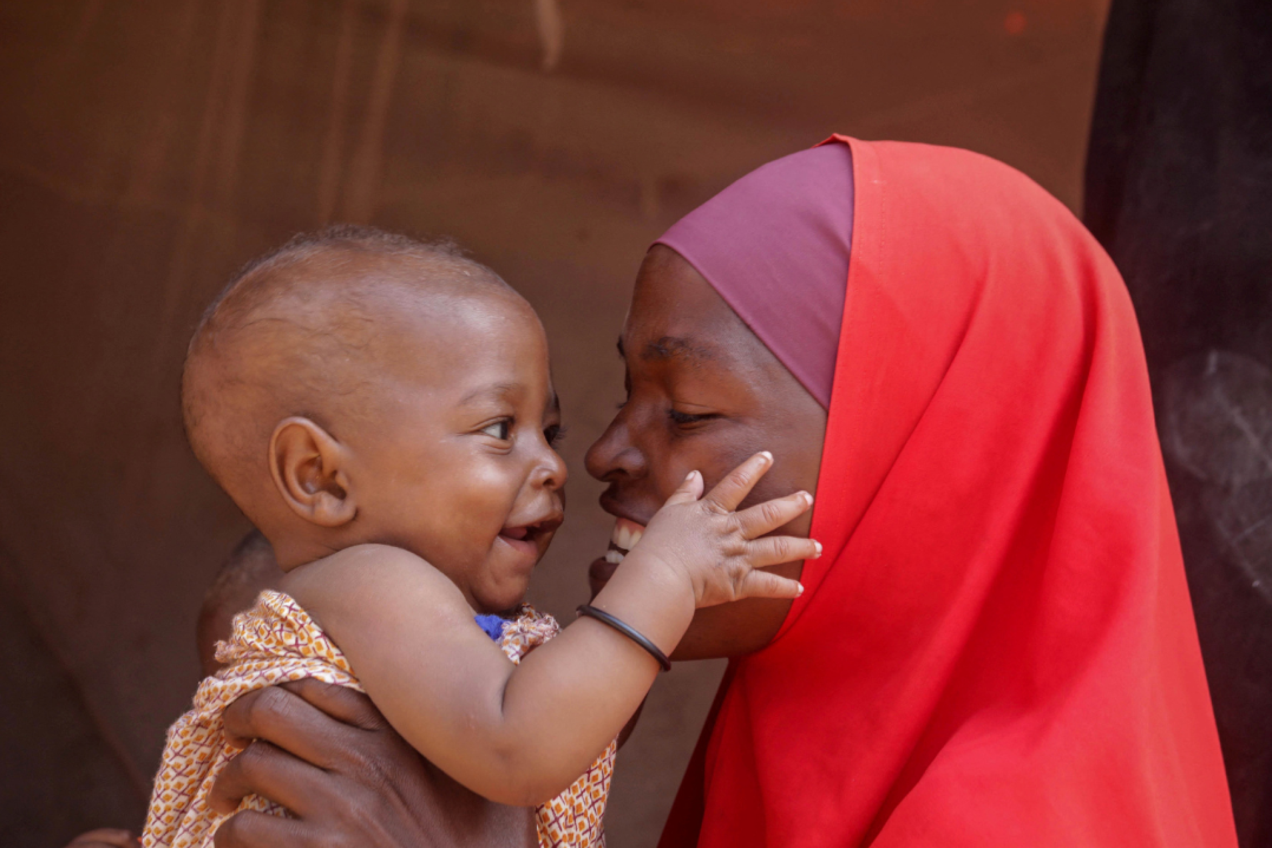 Nadifa Abdi Isak plays with her son Farhan, who recently received an emergency transfusion to treat malnutrition-induced anaemia in Mogadishu, Somalia, on December 1, 2022.