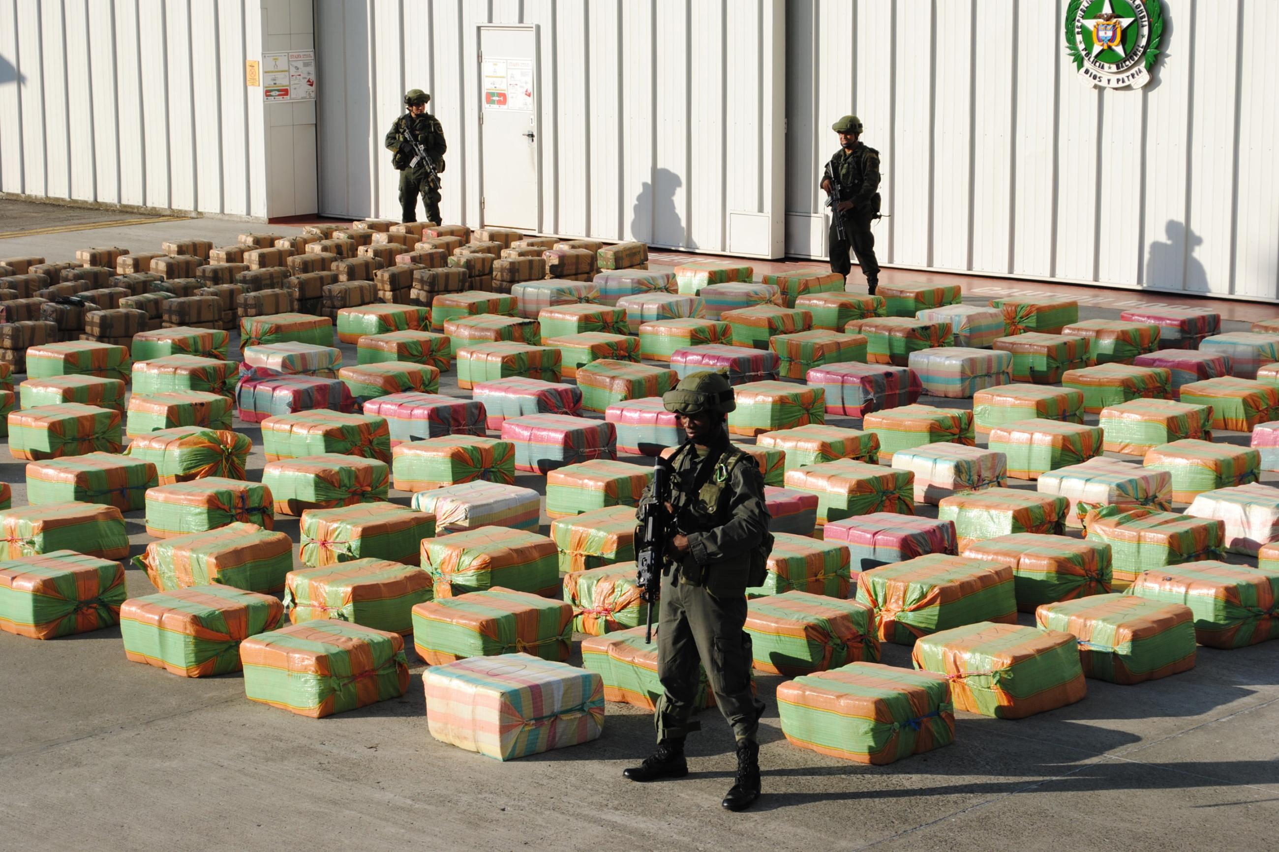 Colombian anti-drugs policemen guard stacks of marijuana seized from the rural area of El Jagual at a military police base in Popayan October, 23, 2011.