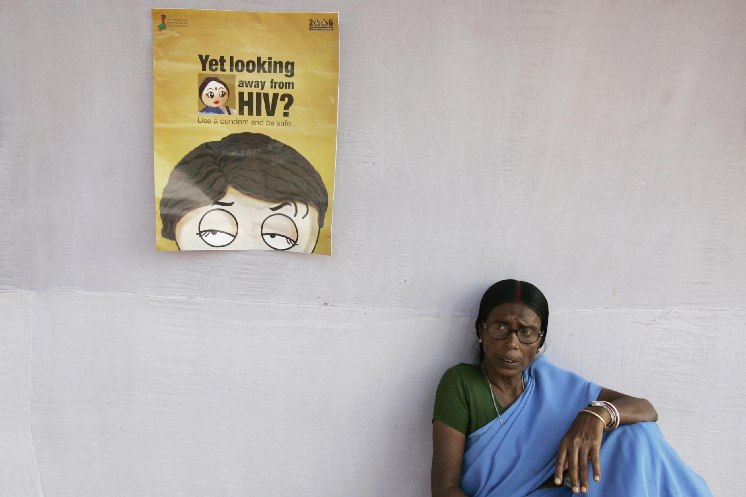 A health worker sits outside a makeshift camp for blood tests on the outskirts of Kolkata, India, on November 30, 2006