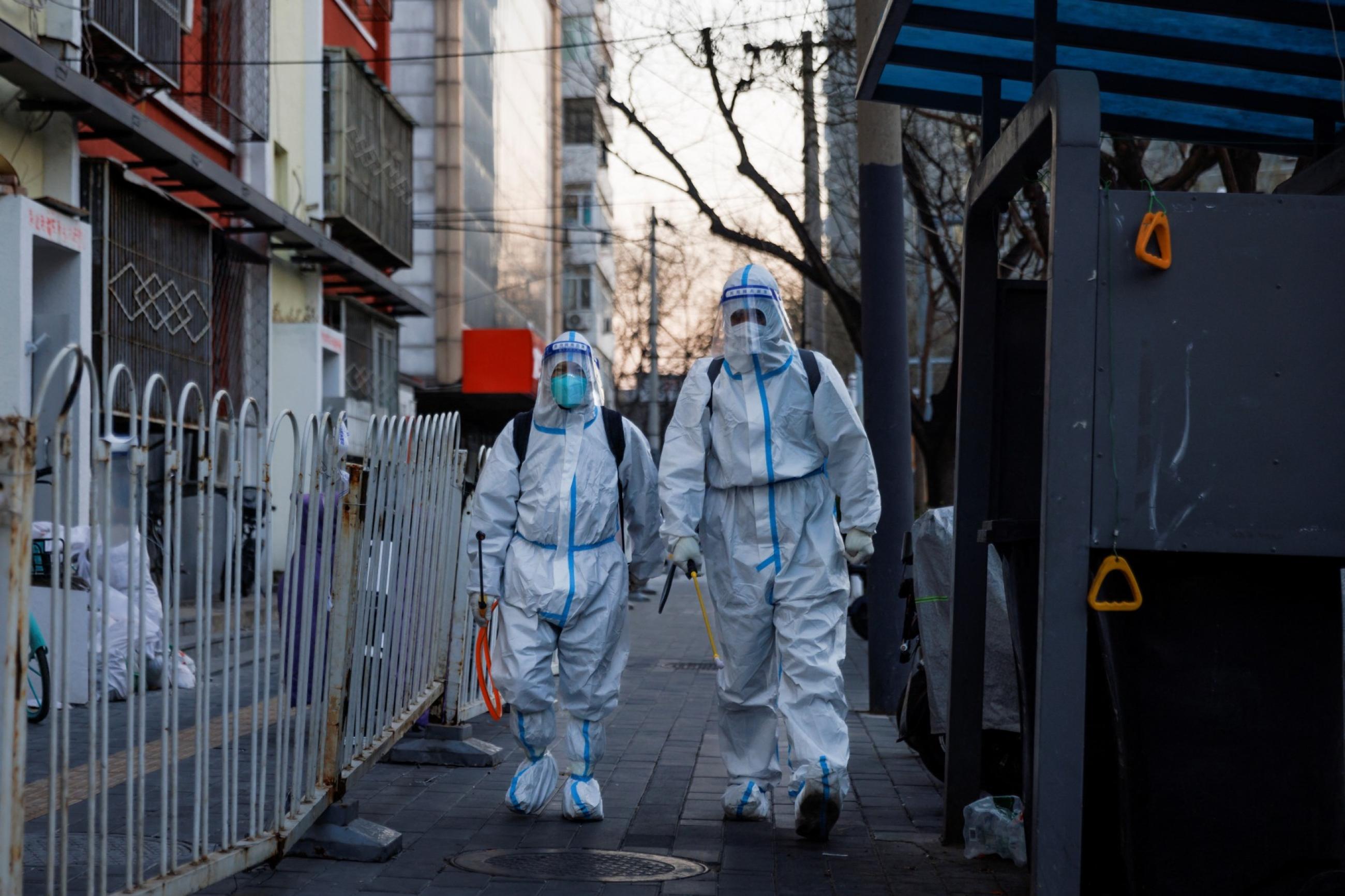 Pandemic prevention workers in protective suits walk in a street as COVID-19 outbreaks continue in Beijing, China, on December 4, 2022.