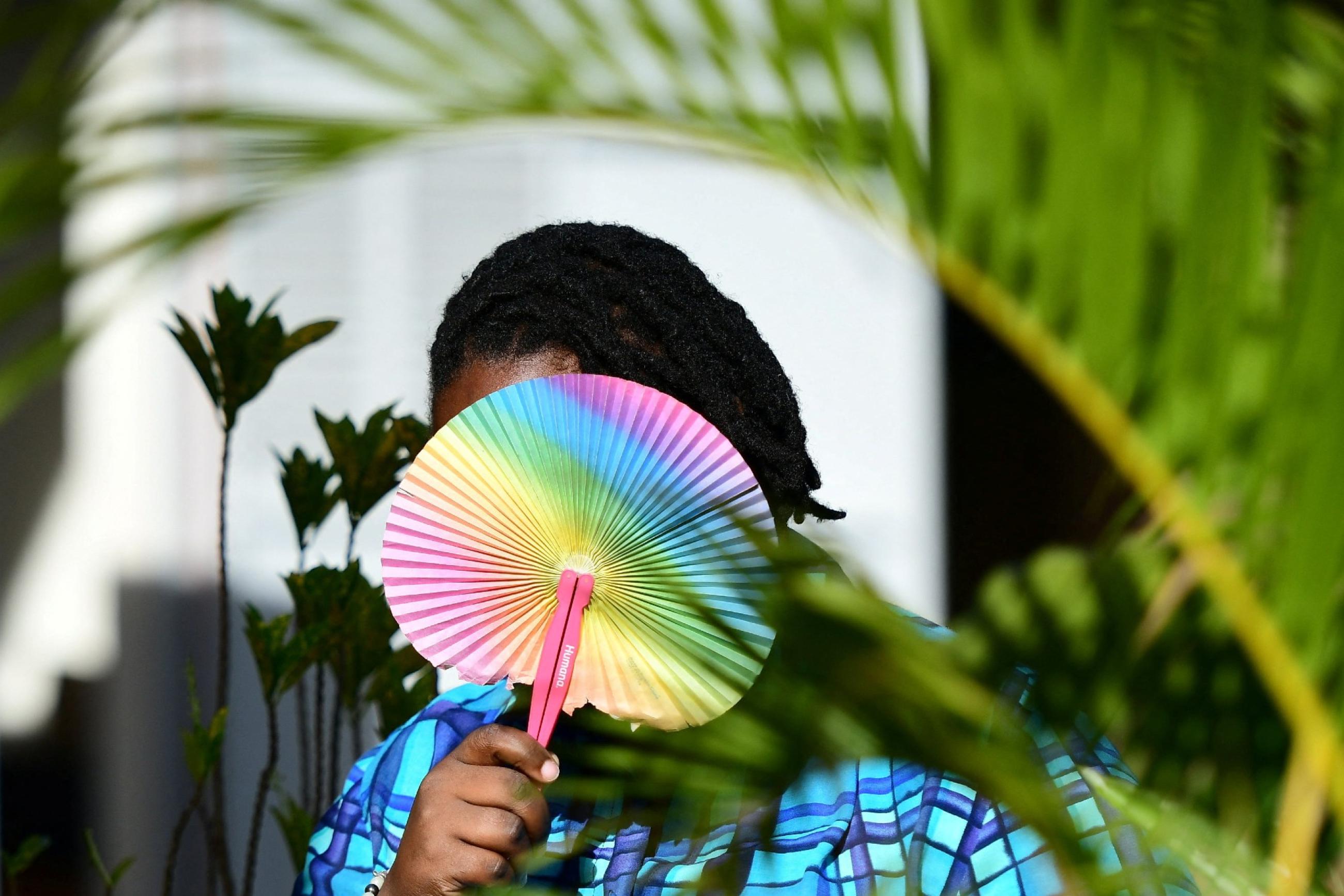 Ashley Karungi 33, a member of the lesbian, gay, bisexual, transgender, intersex and queer (LGBTQ) community and a single mother of two poses for a picture with rainbow colours at the offices of Rella Women's Empowerment Program, for LGBTQ rights advocacy, after a Reuters interview in Kulambiro suburb of Kampala, Uganda April 4, 2023. 