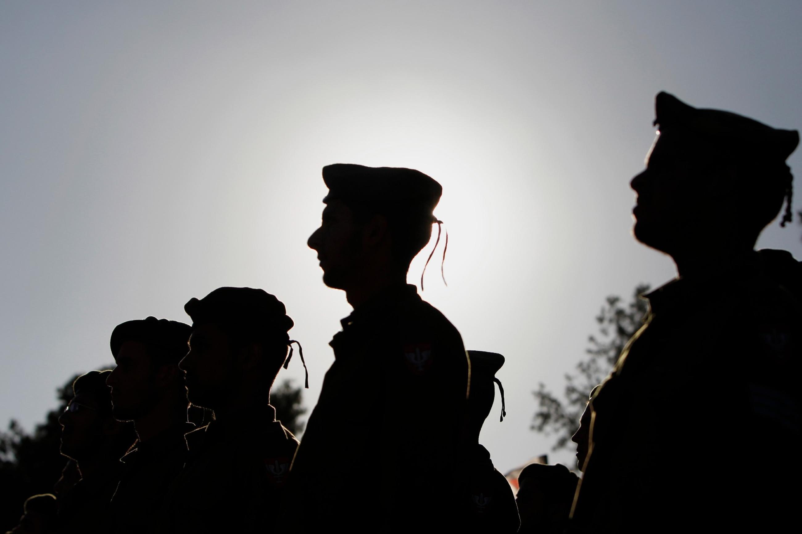 Israeli soldiers of the Netzah Yehuda Haredi infantry battalion stand at attention during their swearing-in ceremony in Jerusalem May 26, 2013,