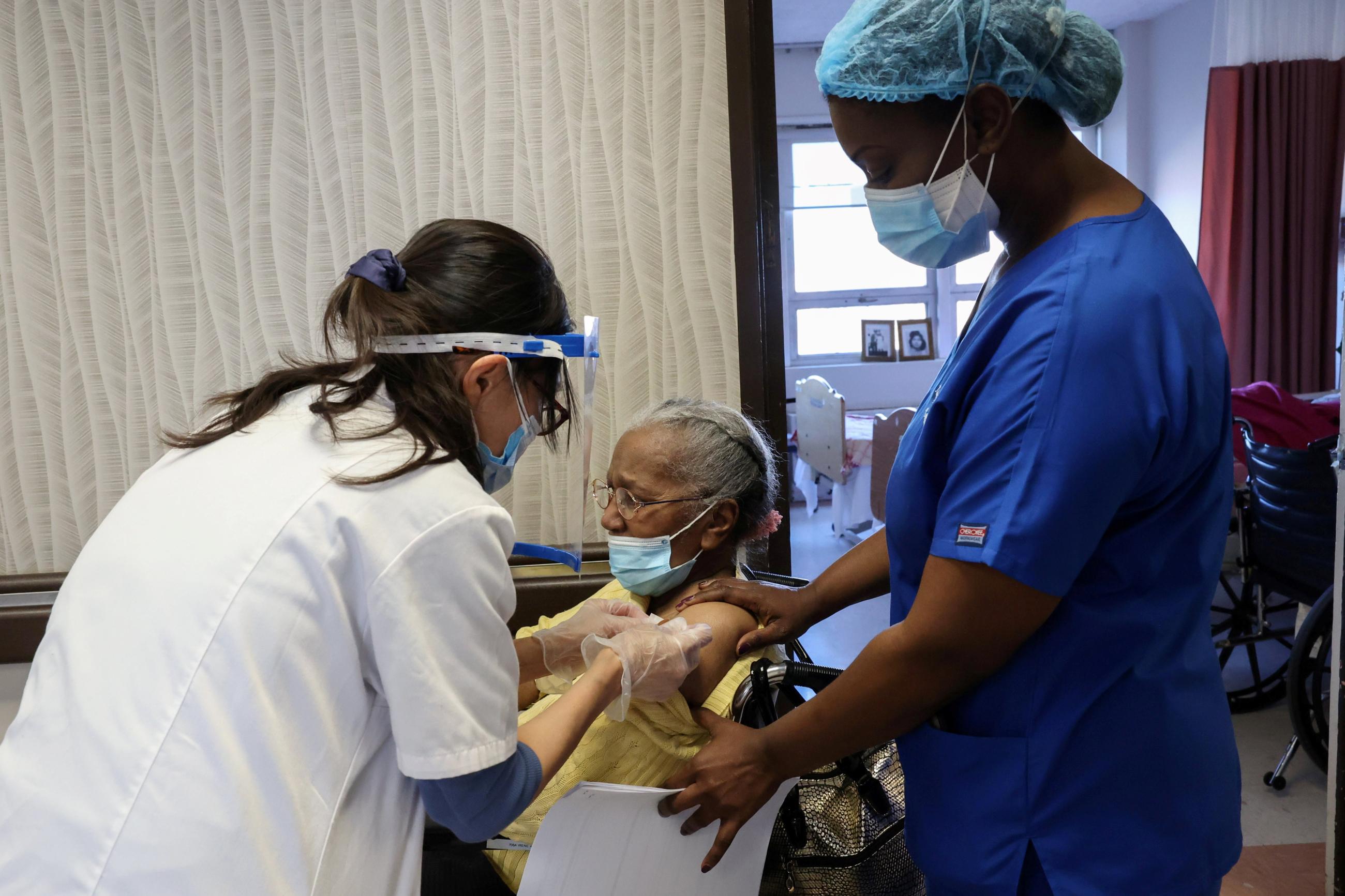 A nursing home resident receives a shot of the coronavirus disease (COVID-19) vaccine at King David Center for Nursing and Rehabilitation, a nursing home facility, in Brooklyn's Bath Beach neighborhood in New York City, U.S. January 6, 2021. 