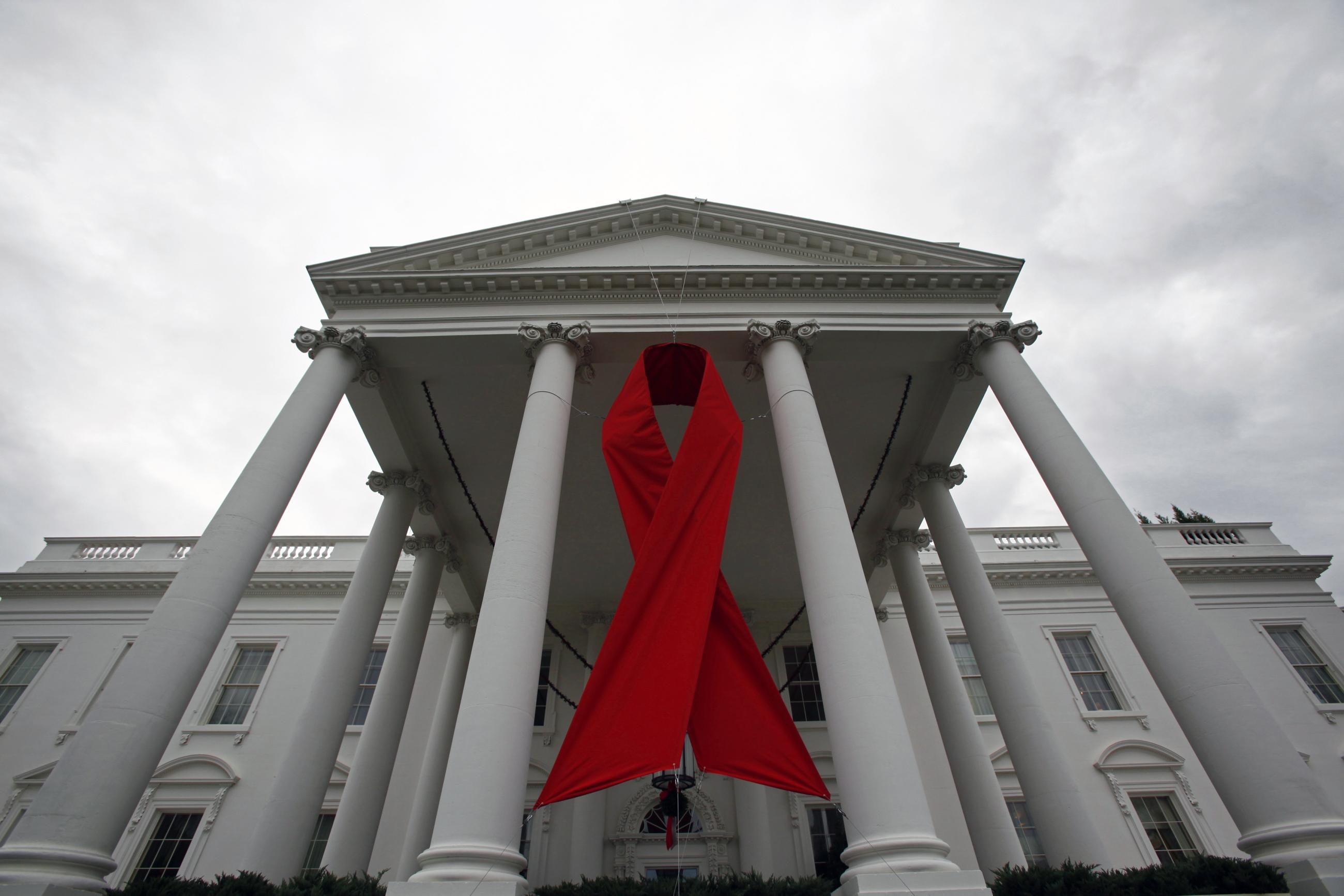 An AIDS ribbon hangs from the North Portico of the White House.