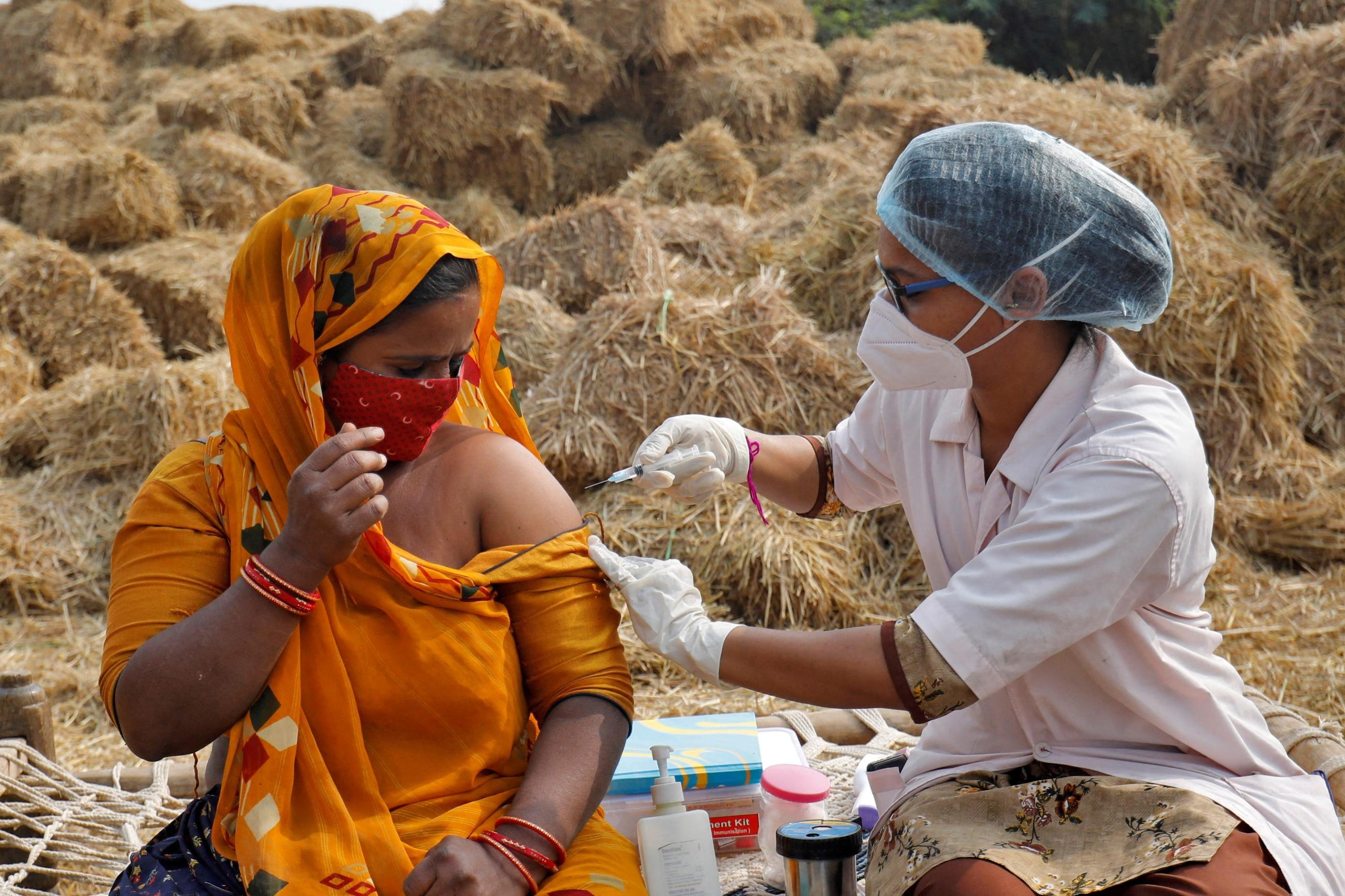 A woman receives a dose of COVISHIELD vaccine against COVID-19, that's manufactured by Serum Institute of India.