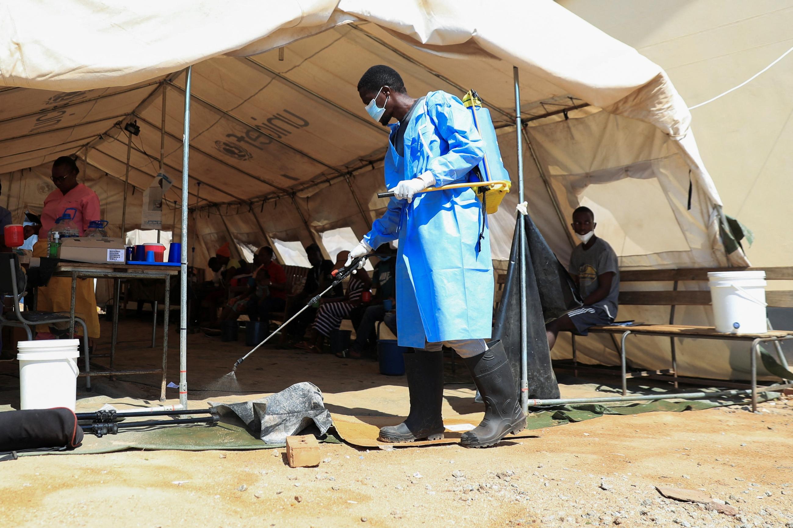 A health worker disinfects a cholera tent at Kuwadzana Polyclinic in Harare.