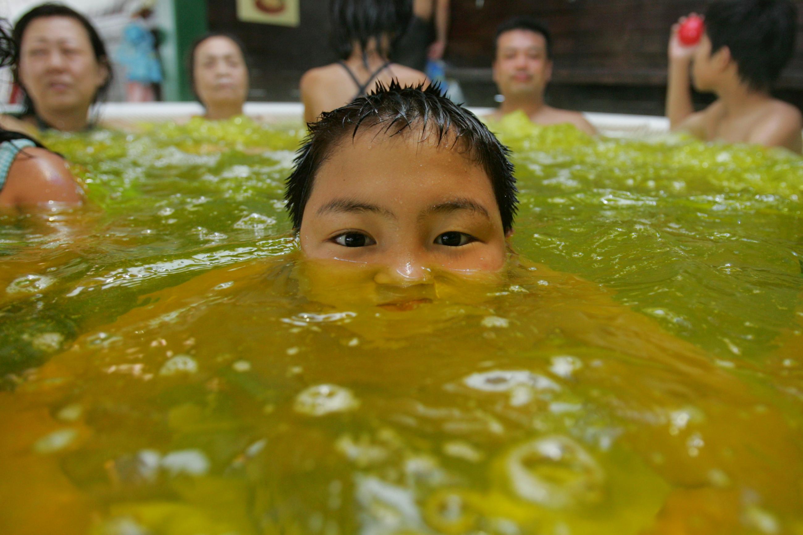 A boy soaks himself in a hot bath infused with curry spices to improve blood flow and the appearance of skin.