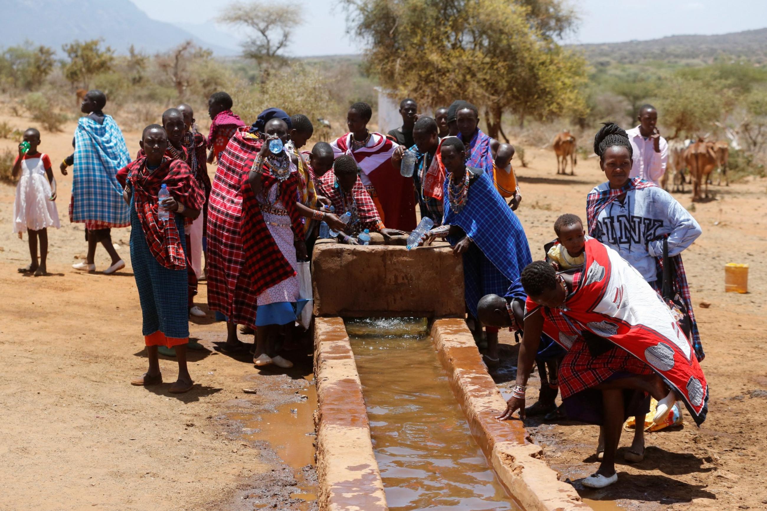 Traditional Maasai women collect water from a borehole, at the Lositeti village, in Matapato North, Kajiado County, Kenya, on February 26, 2023. 