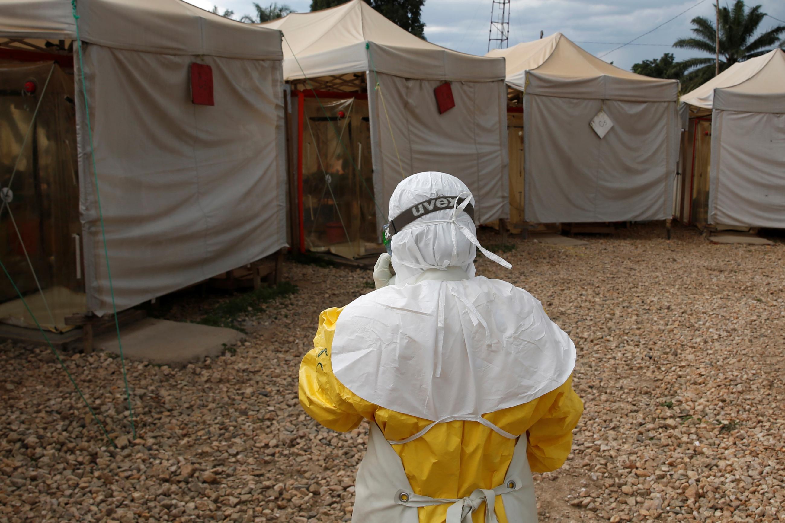 A health worker wearing ebola protection gear, stands outside the Biosecure Emergency Care Unit at the ALIMA Ebola Treatment Center.