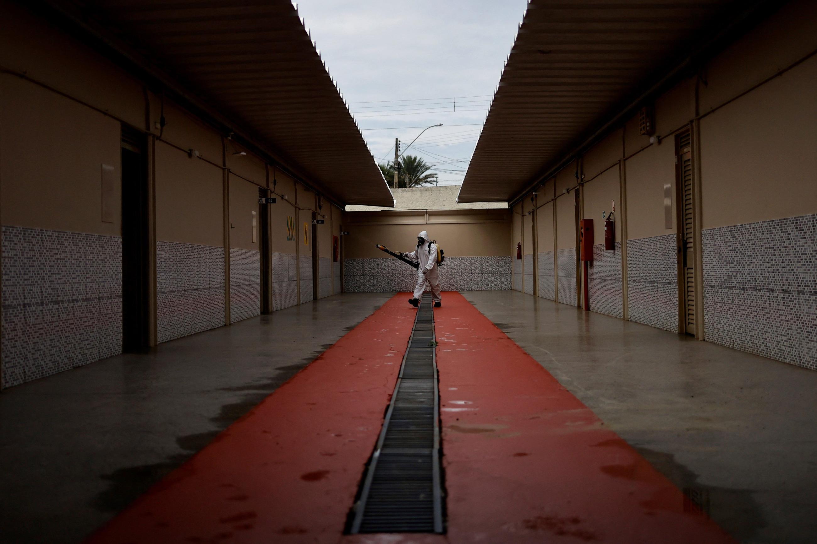 A health worker sprays insecticide to kill the Aedes aegypti mosquitos to help mitigate a dengue outbreak at a public school in Brasilia, Brazil February 16, 2024.