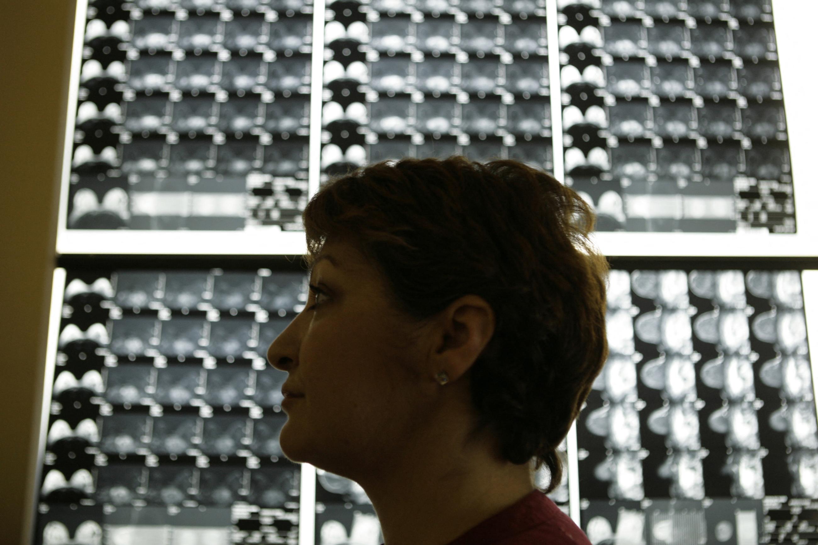 Vasiliki Kostoula, a breast cancer patient, listens to her doctor after a radiological medical examination
