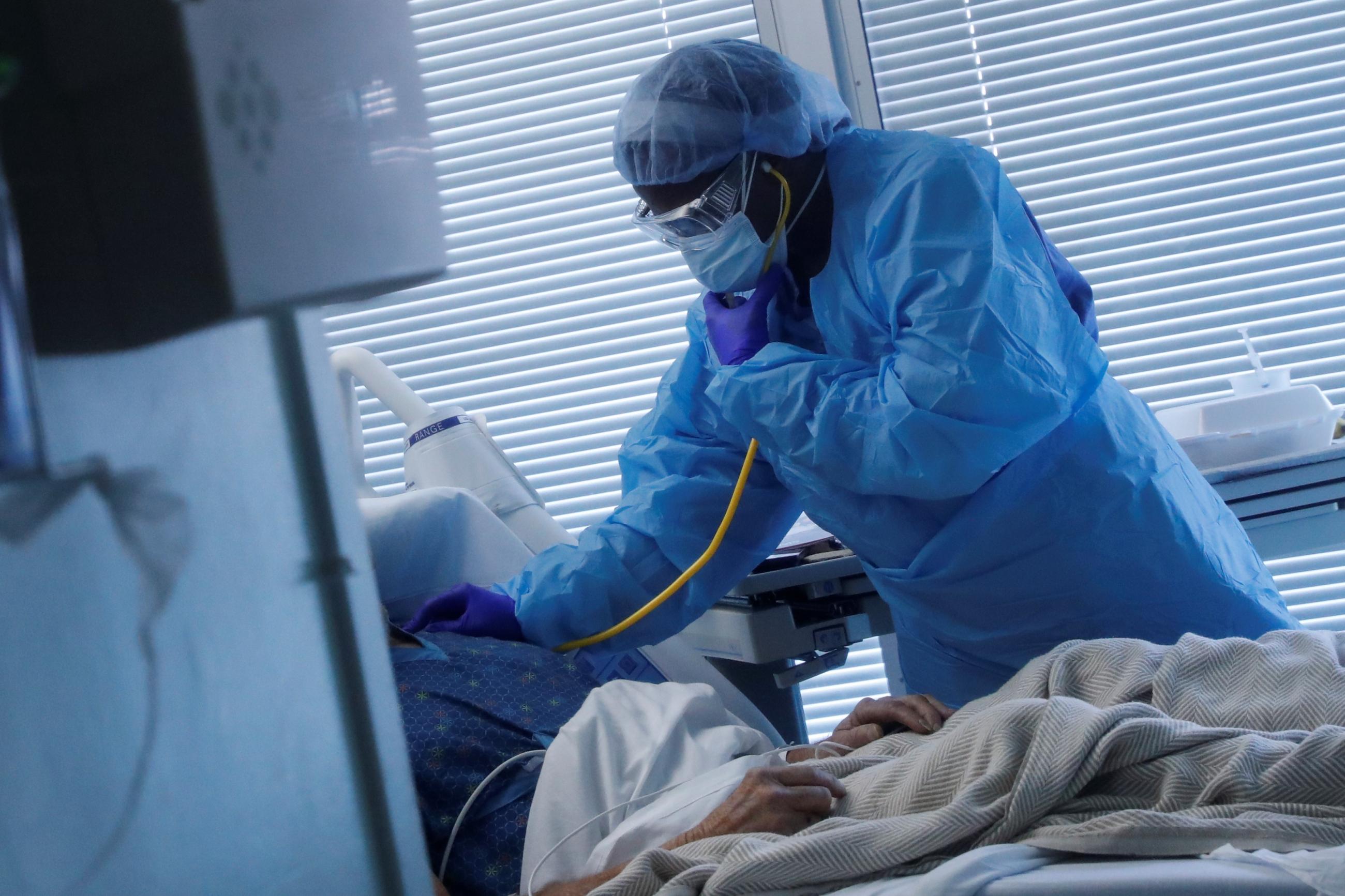 Registered Nurse LaToya Marks treats a COVID-19 positive patient at University of Arkansas for Medical Sciences.
