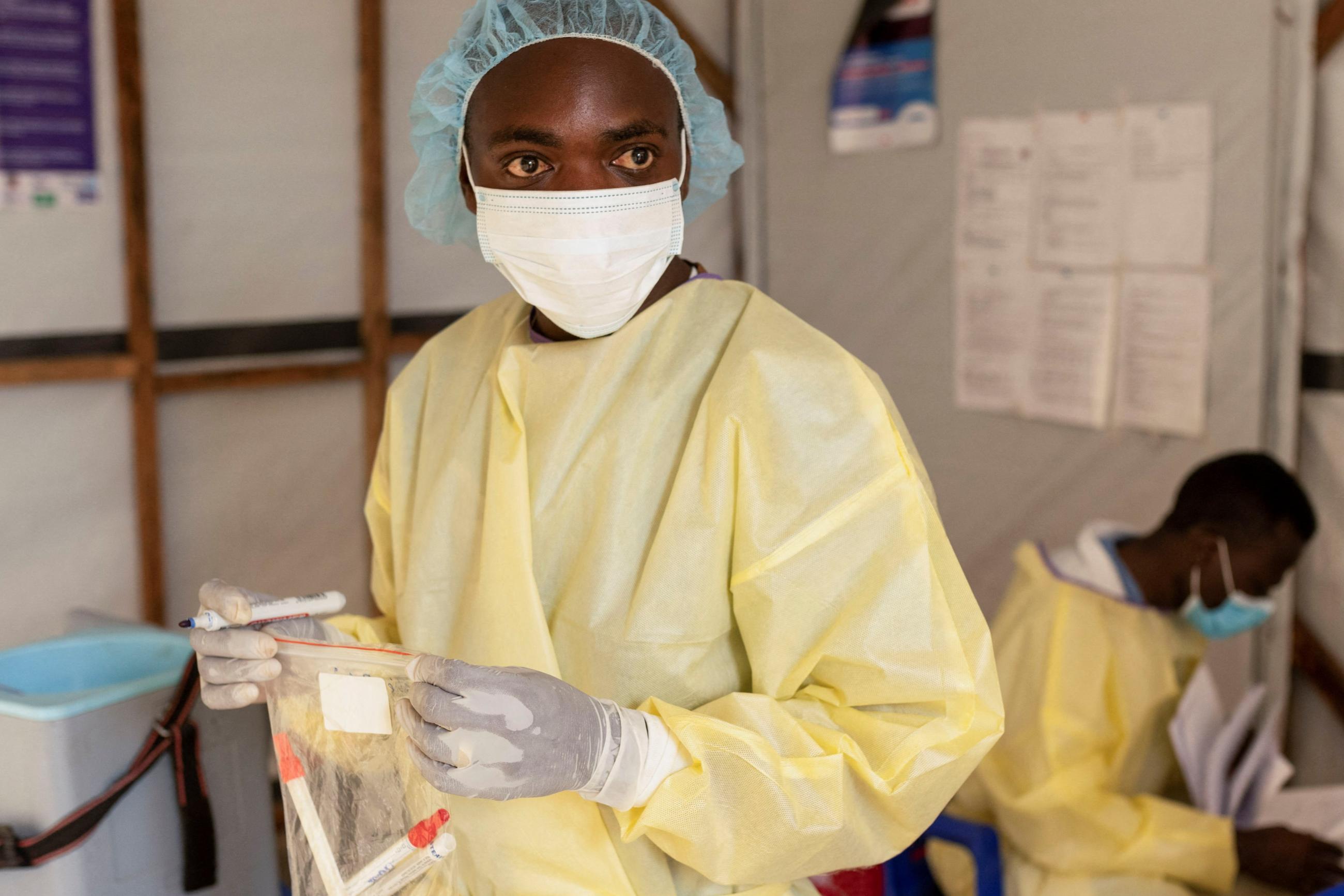 A laboratory nurse carries samples taken from a child with a suspected case of mpox.