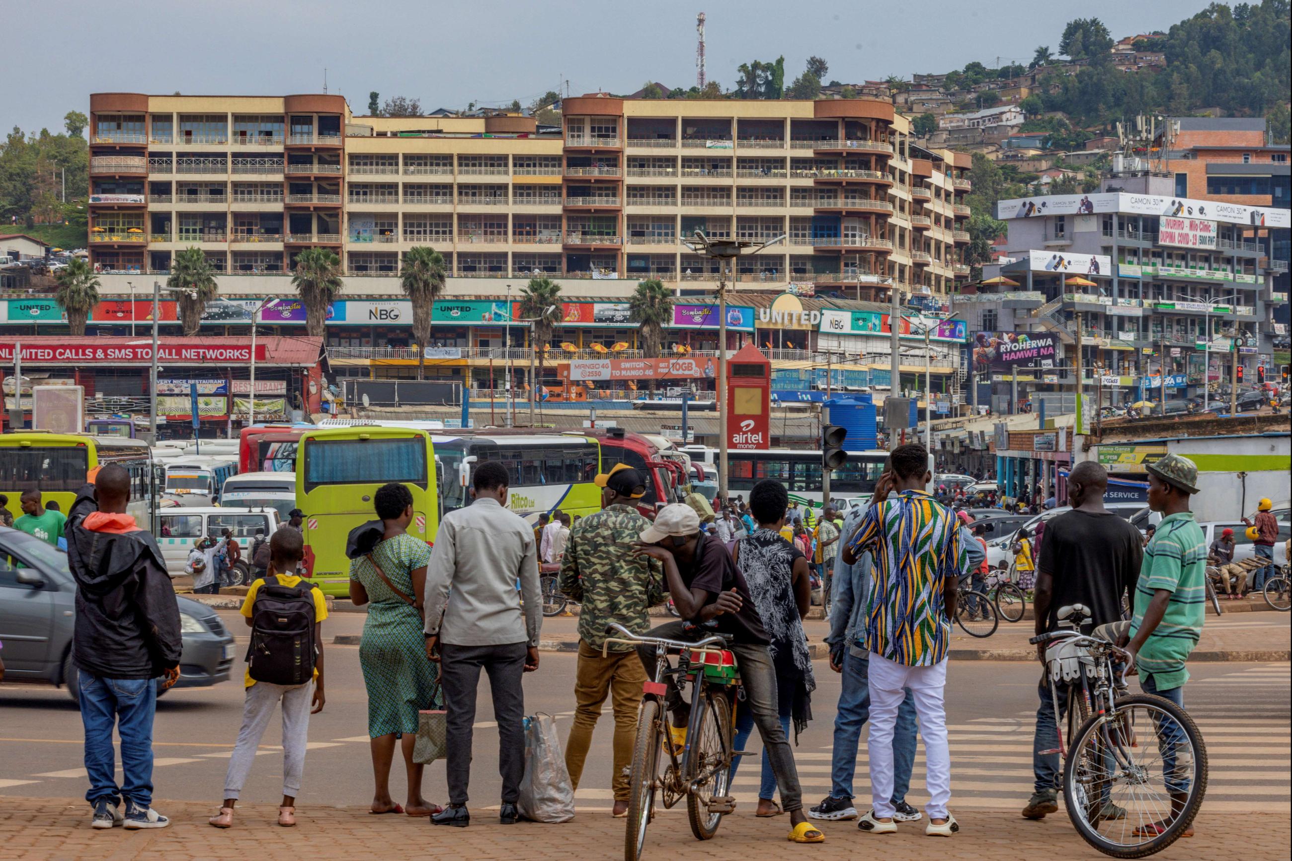 Pedestrians wait to cross a street in Kigali, Rwanda, April 26, 2024.