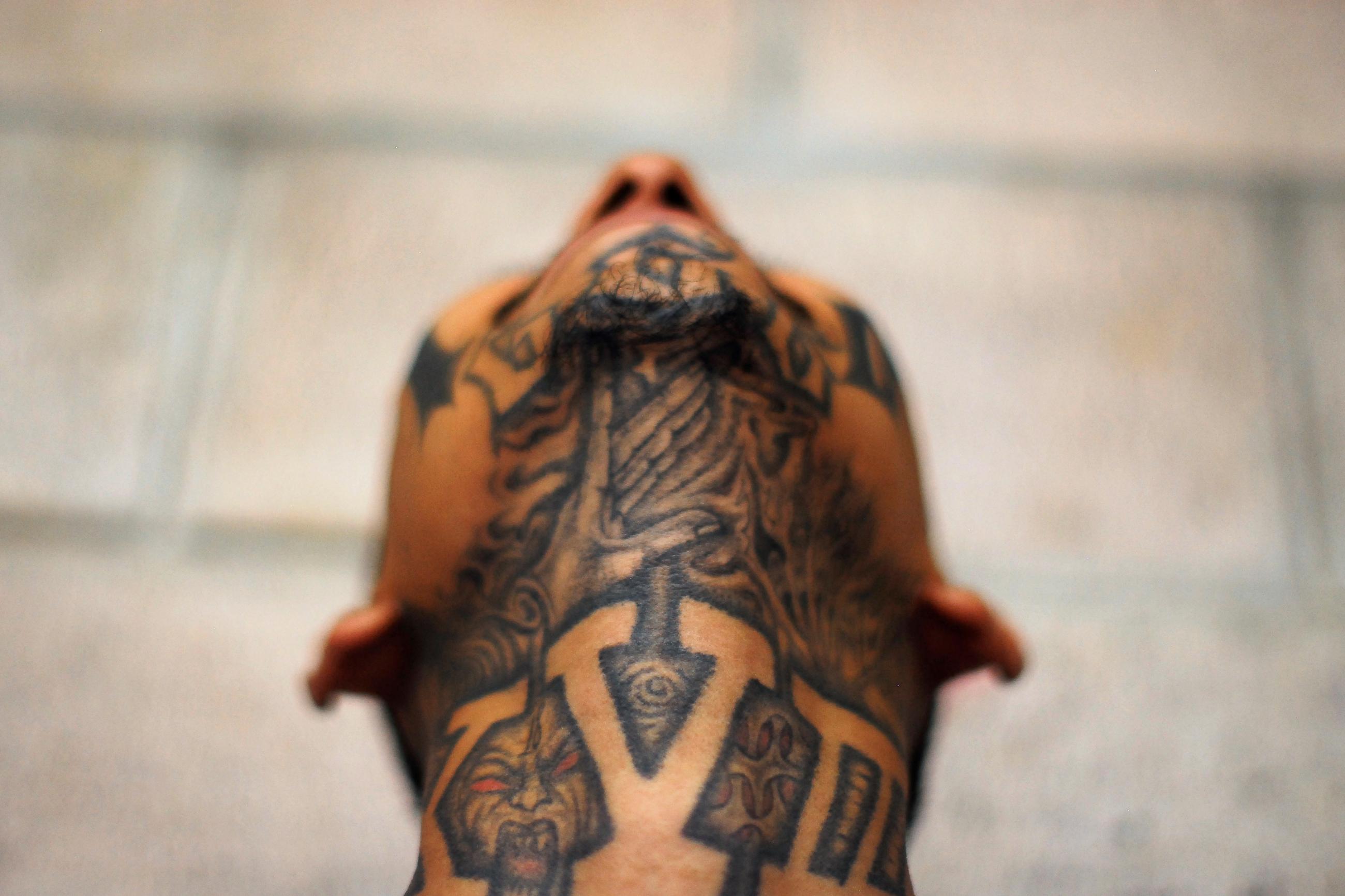 An imprisoned member of street gang Mara 18 poses for a photograph at the Izalco prison.