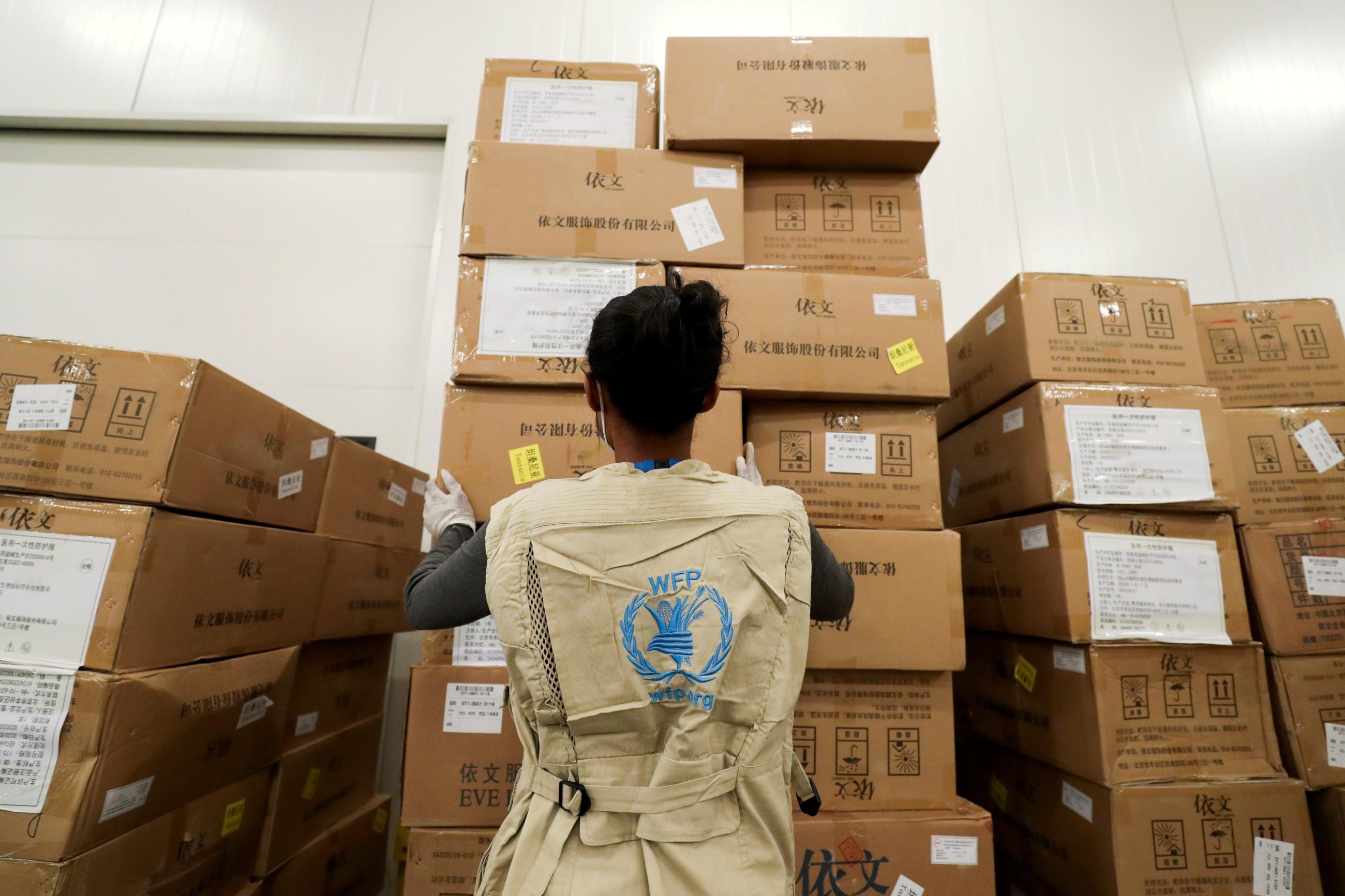 A World Food Program worker arranges relief packages designated to the United Nations for humanitarian aid for Africa to combat the outbreak of COVID-19.